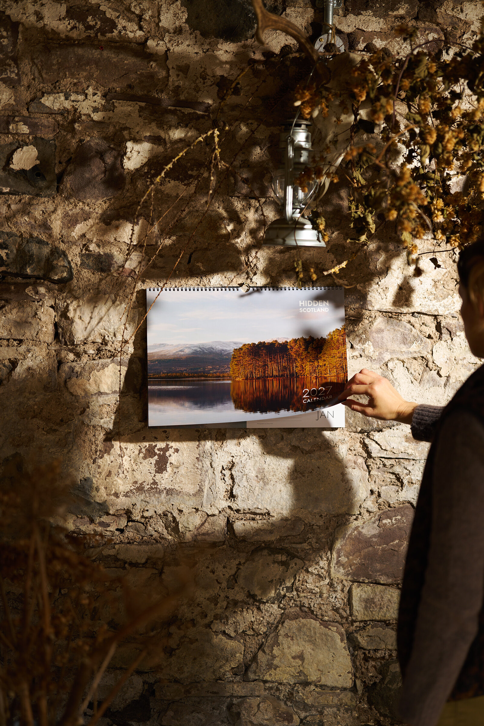 Turning the 2027 calendar on a stone wall