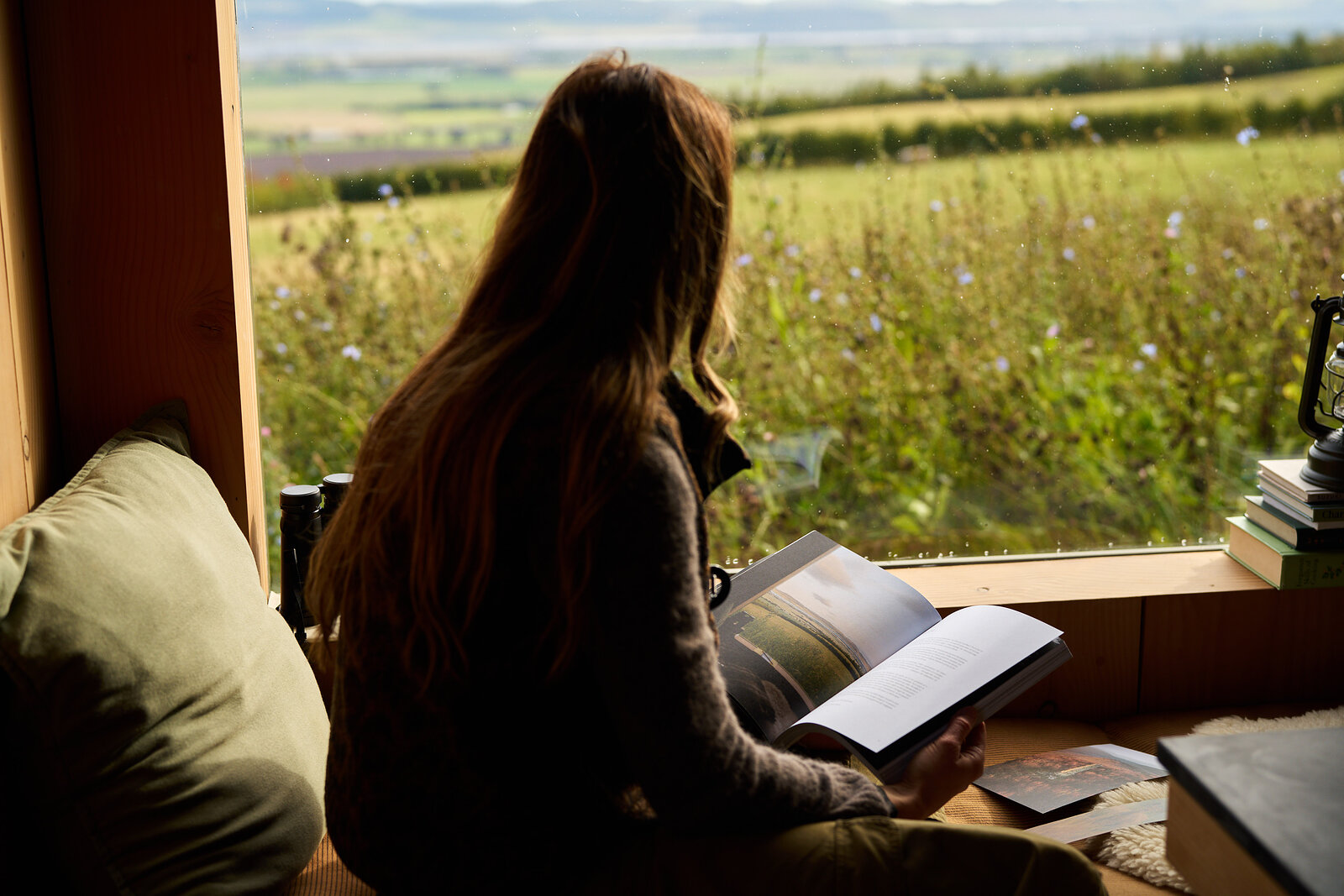 Reading Issue 13 in a window seat over open fields