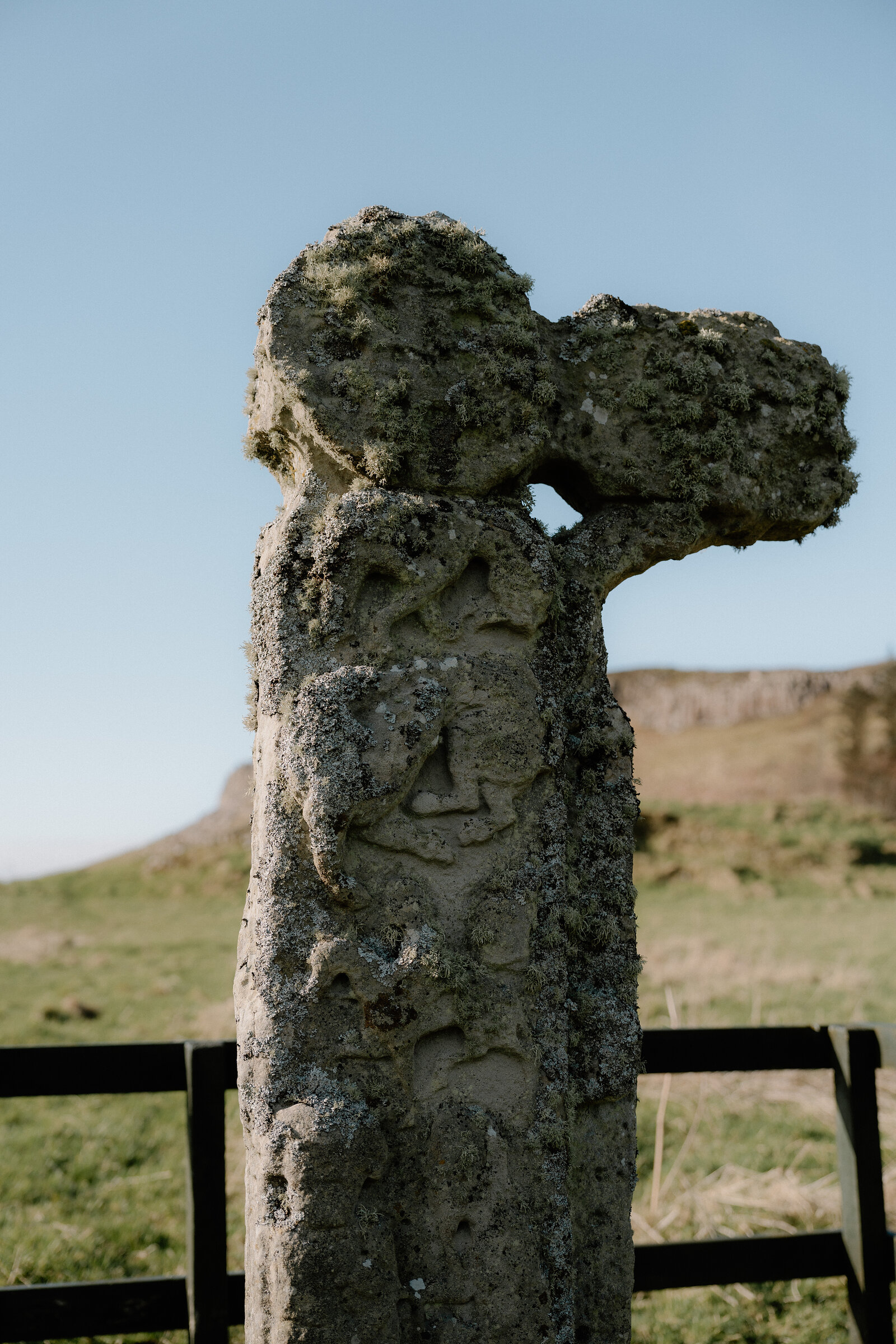 A close view shows carved interlace patterns on the shaft of the Isle of Canna's ancient stone cross.