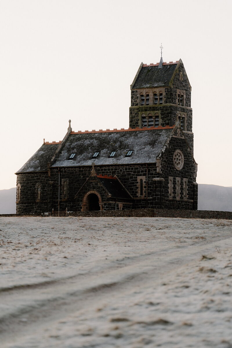 St Edward's on the top of Sanday above a frosted track, hills behind.