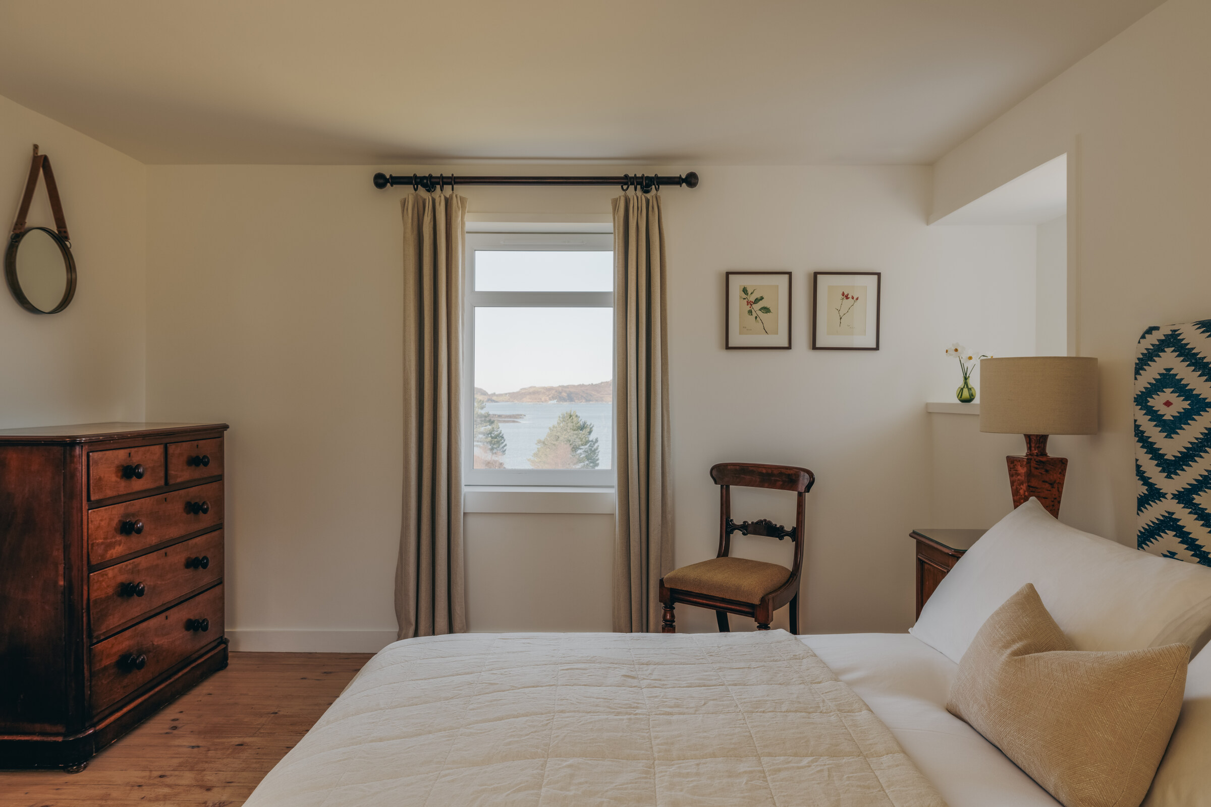 Rhuroin’s double bedroom, with an old chest of drawers and a window onto the loch.