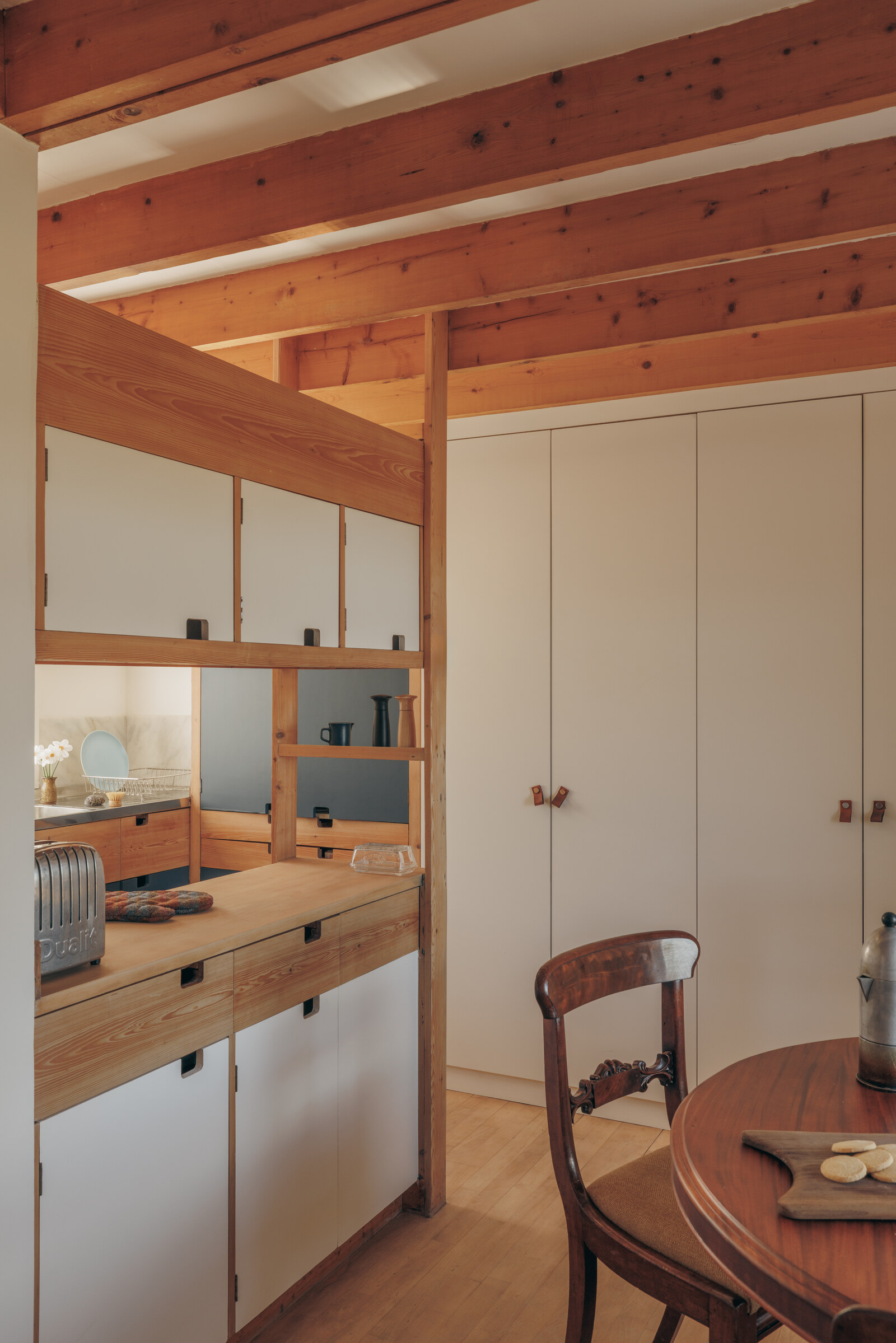 Rhuroin’s kitchen under its wooden beams, beside the round dining table.