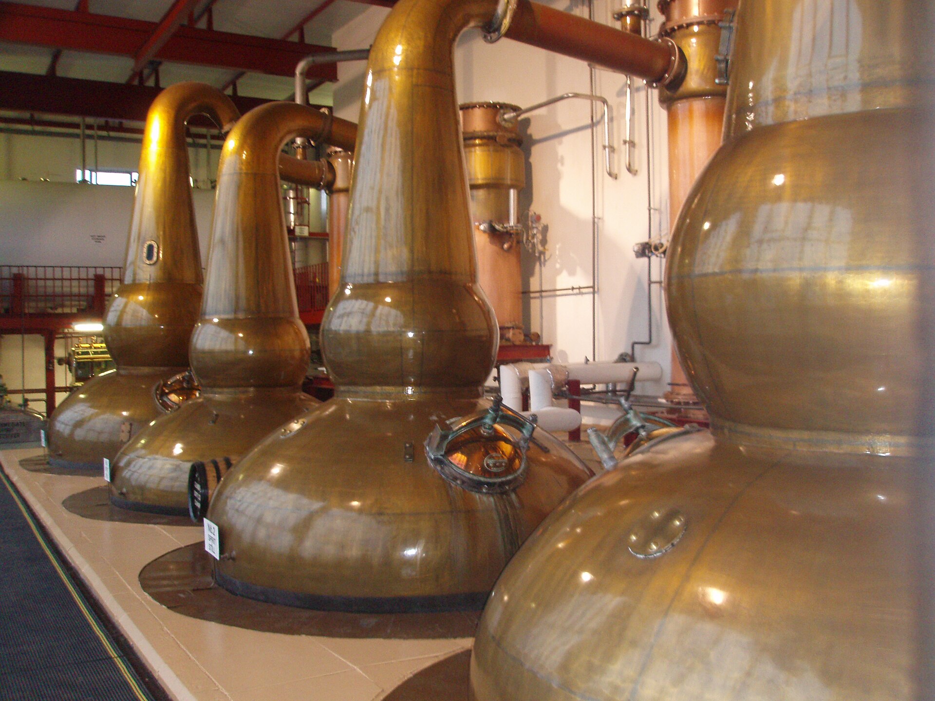 Tall copper pot stills in the stillhouse at the GlenDronach Distillery.