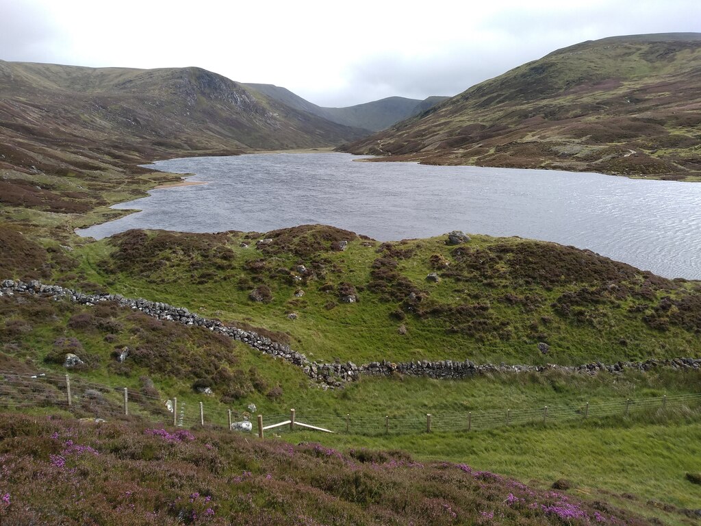 Loch Callater lying in its glen between heather slopes and hills.