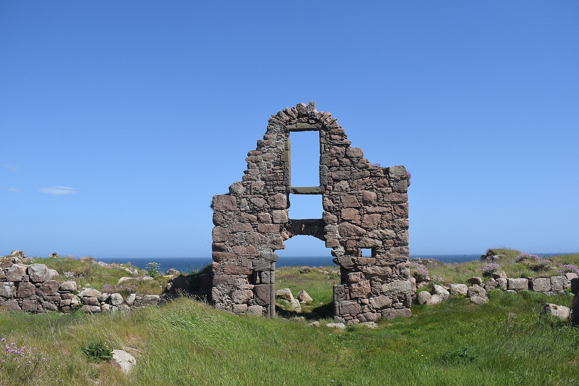 The broken gable of Boddam Castle, a window open to the sky, on its rocky point above the sea.