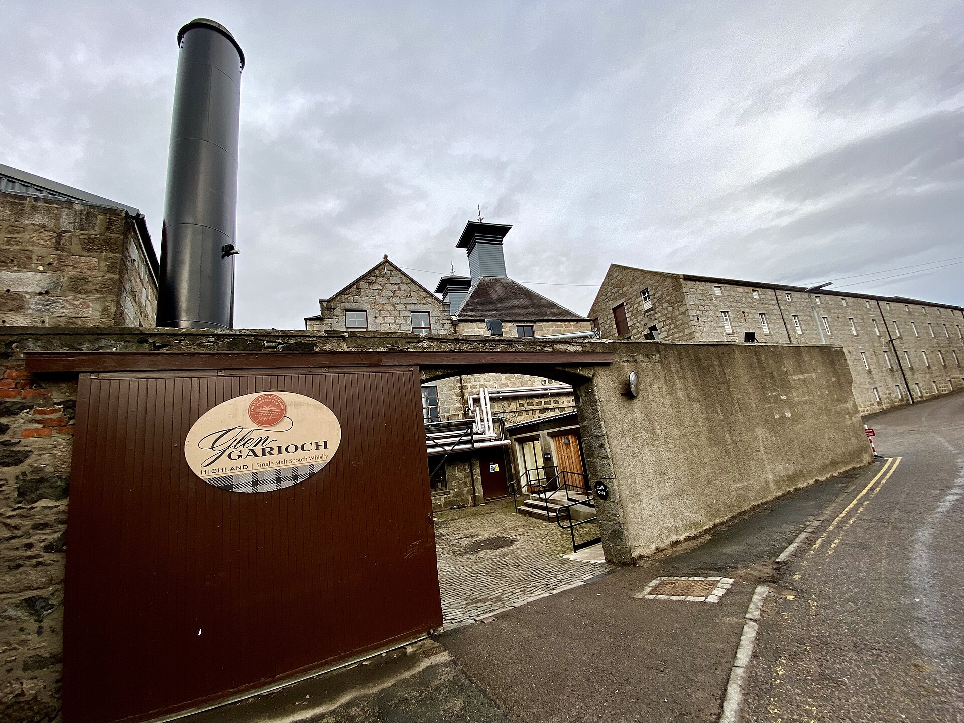 The whitewashed buildings and tall chimney of Glen Garioch Distillery in Oldmeldrum.