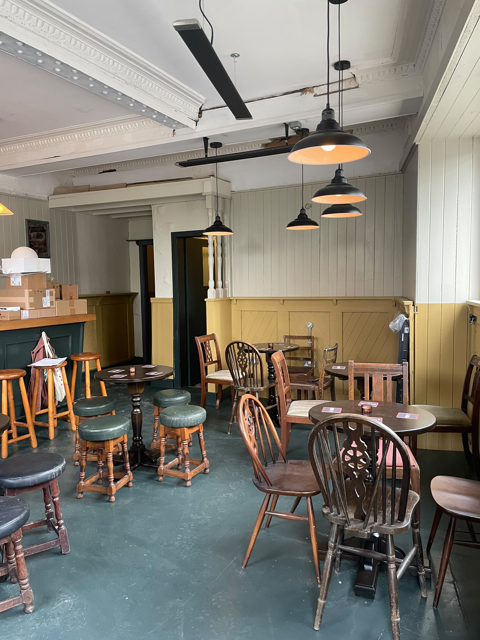The refurbished room at Tamson's Bar, with panelled walls, pendant lights and wooden chairs and stools.