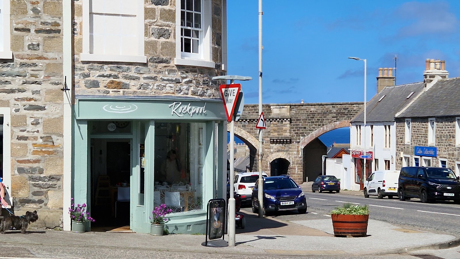 The Rockpool café on a street corner beneath a stone railway viaduct