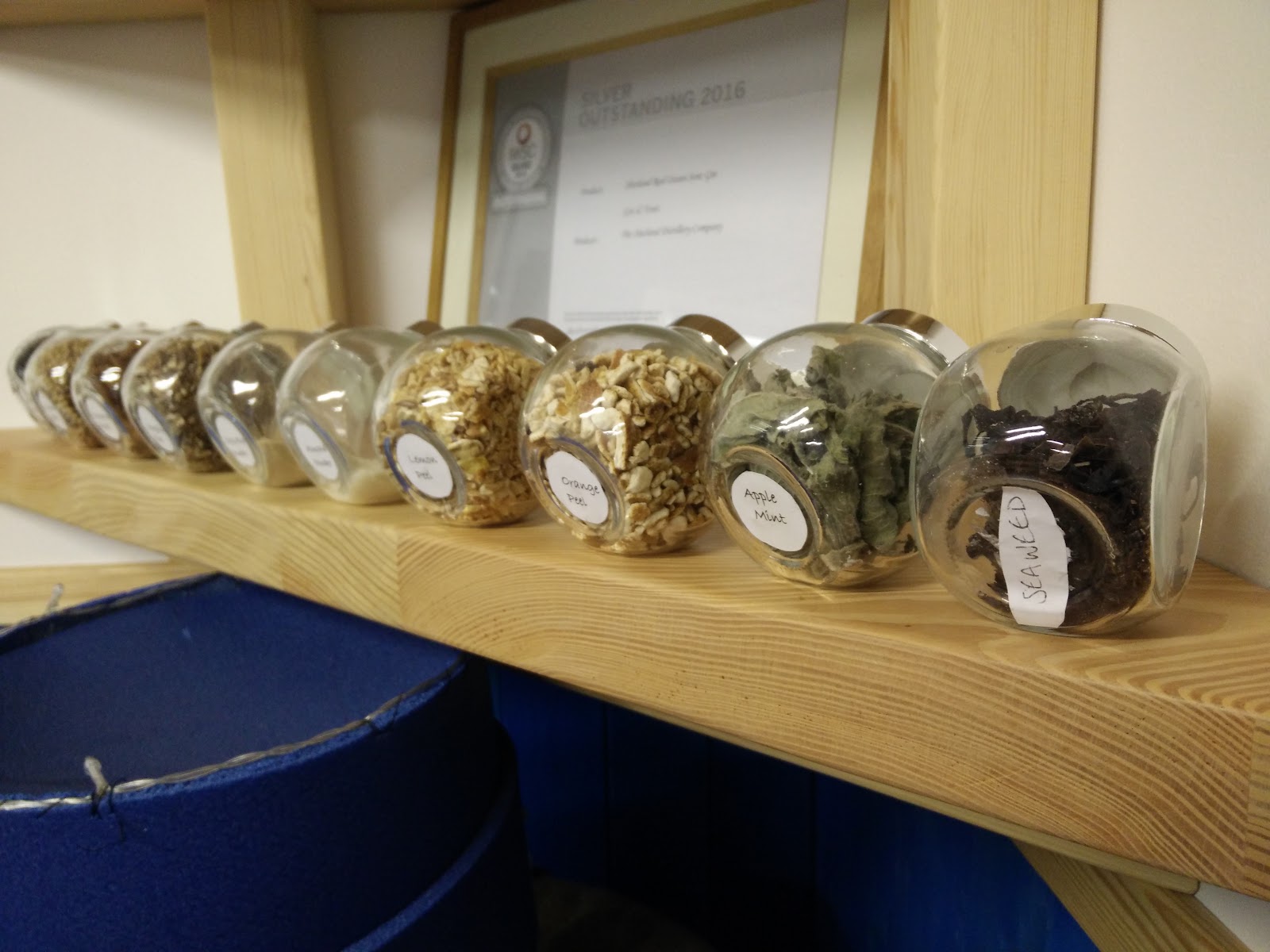 Jars of gin botanicals on a wooden shelf in the Saxa Vord Distillery.