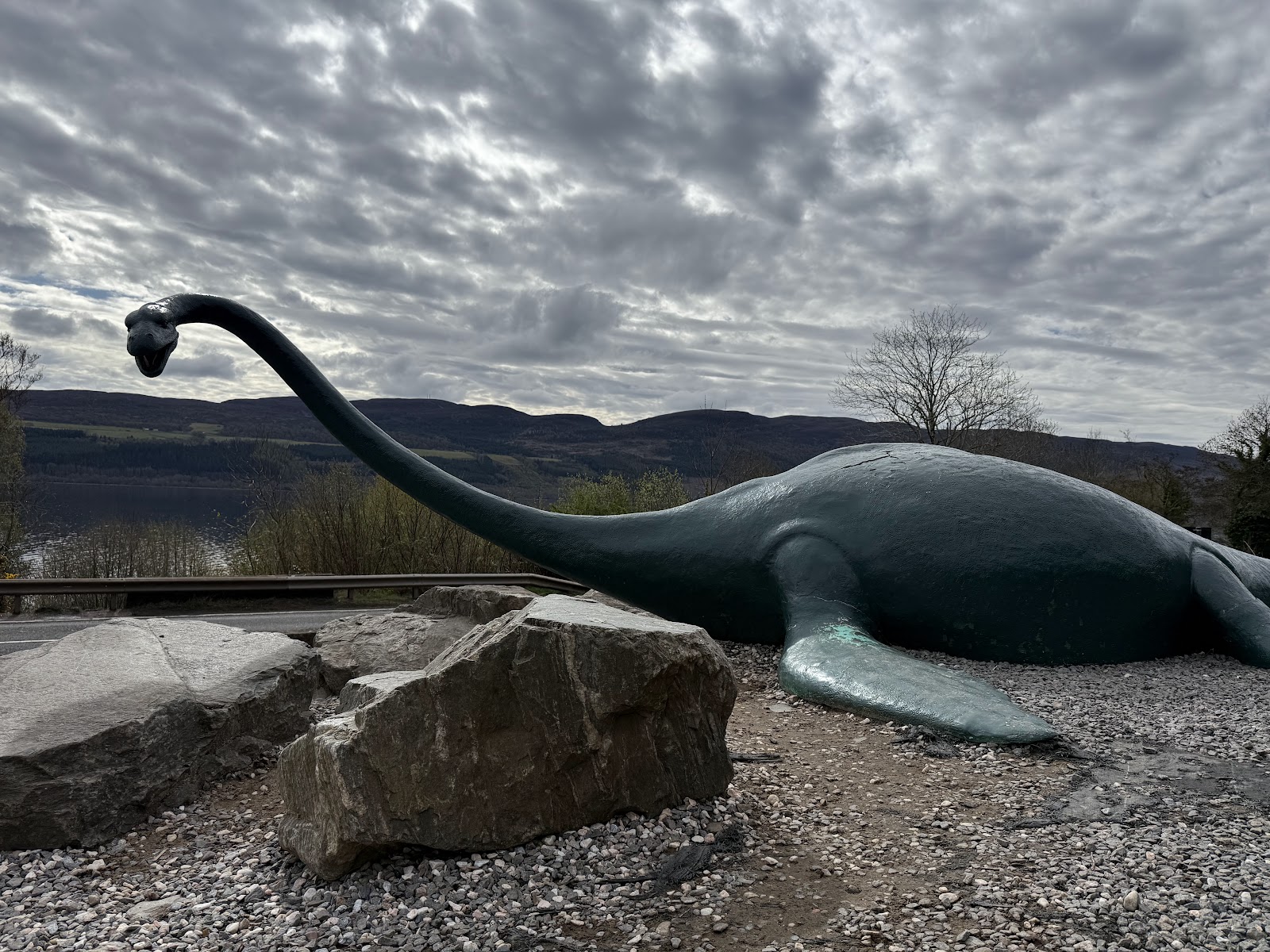 Nessie model overlooking Loch Ness beside the roadside viewpoint
