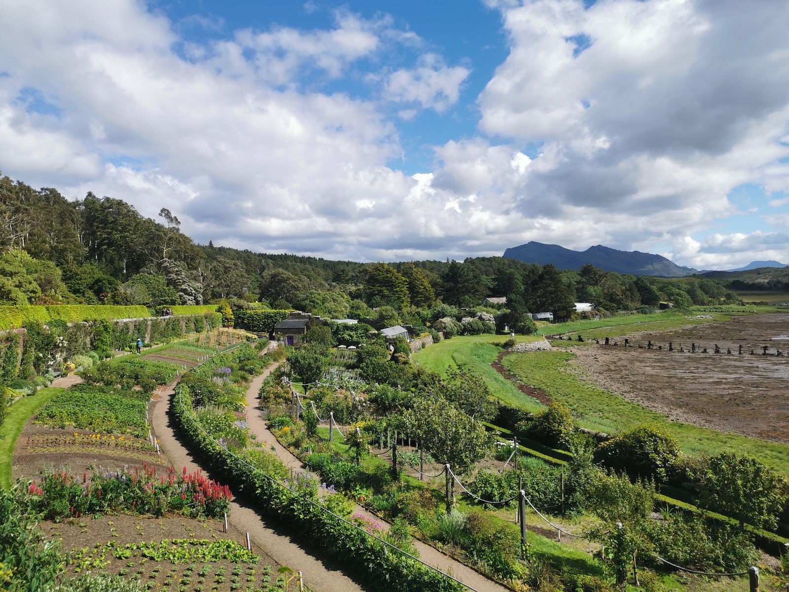 The terraced walled garden at Inverewe, curving beds running down towards the loch and hills.