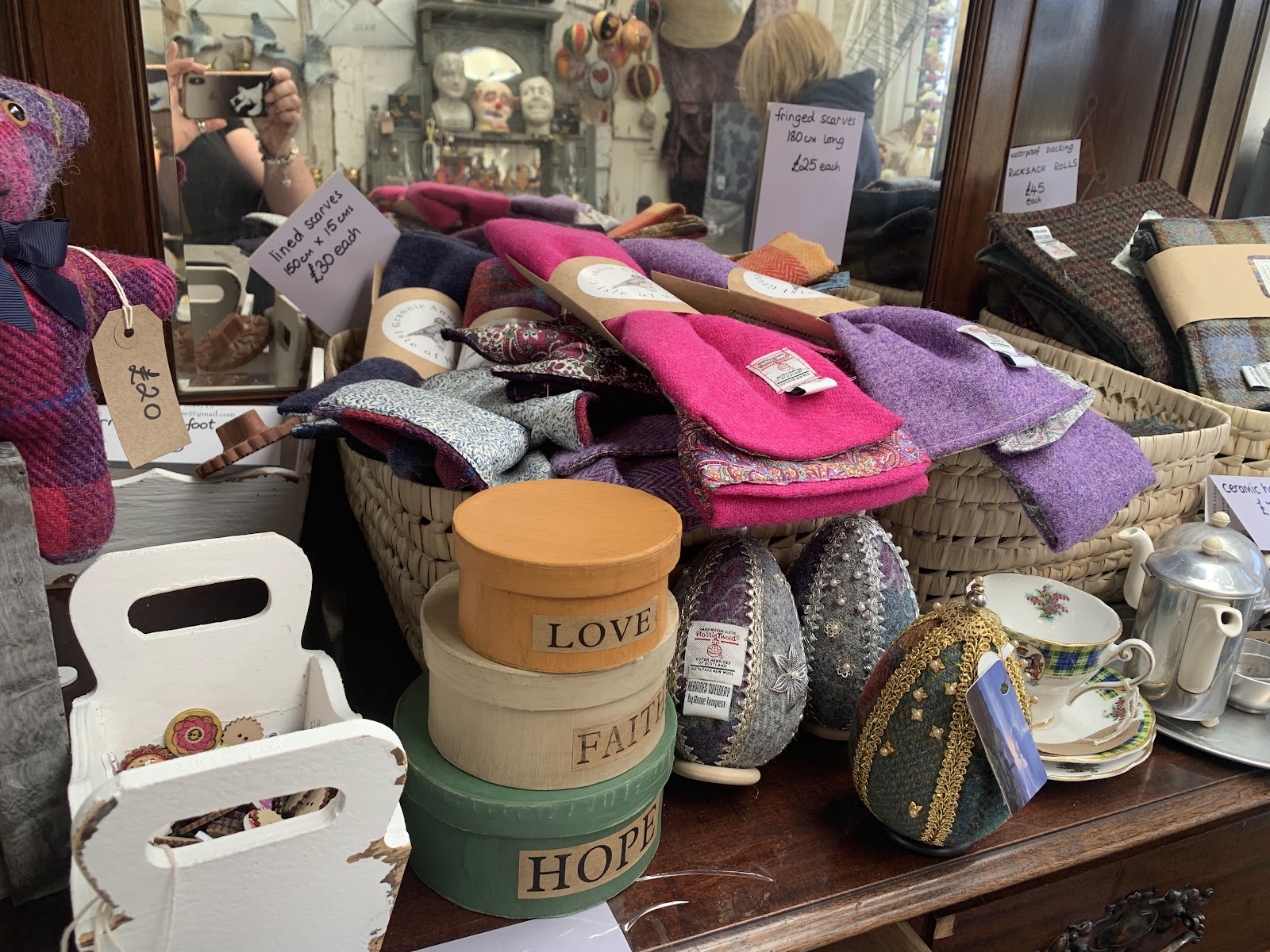 Tweed scarves, "Love, Faith, Hope" boxes and Harris Tweed eggs on a shop counter