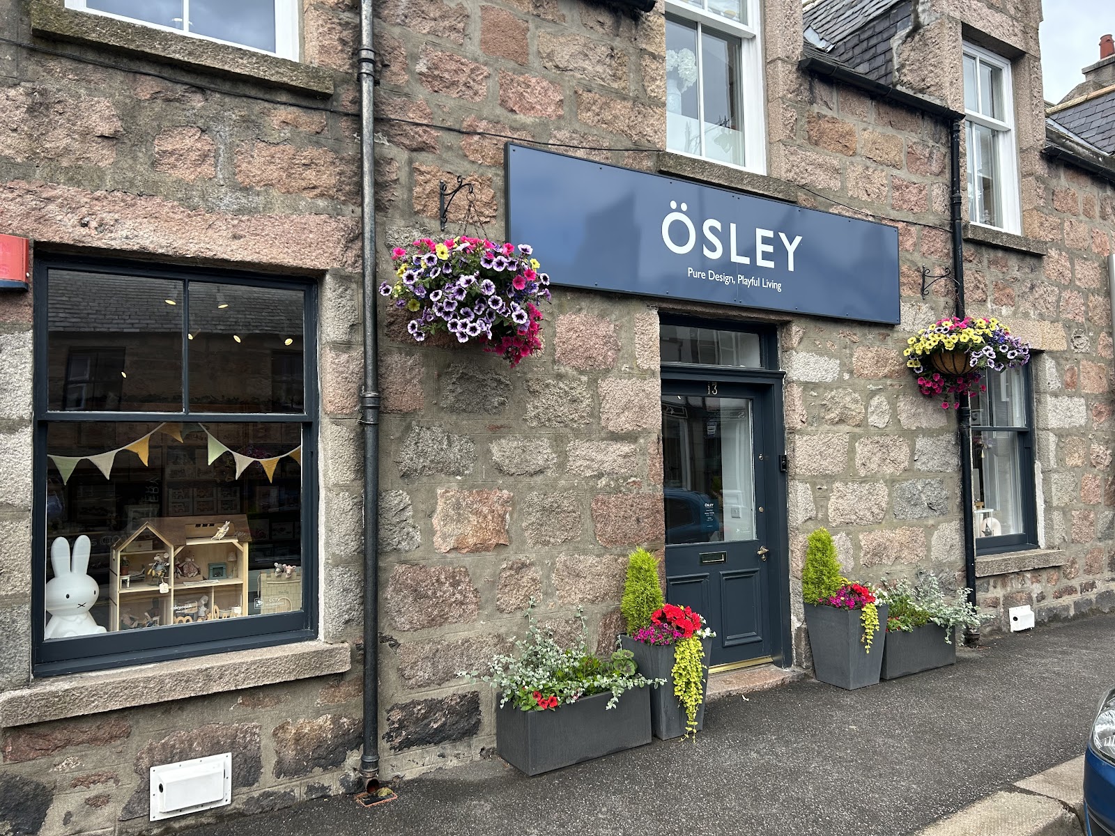 ÖSLEY's granite front on Bridge Street, Ballater, a navy sign above the door.