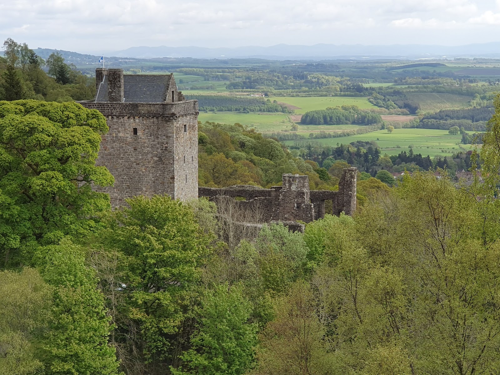 Castle Campbell's tower above the wooded glen, farmland stretching away below.