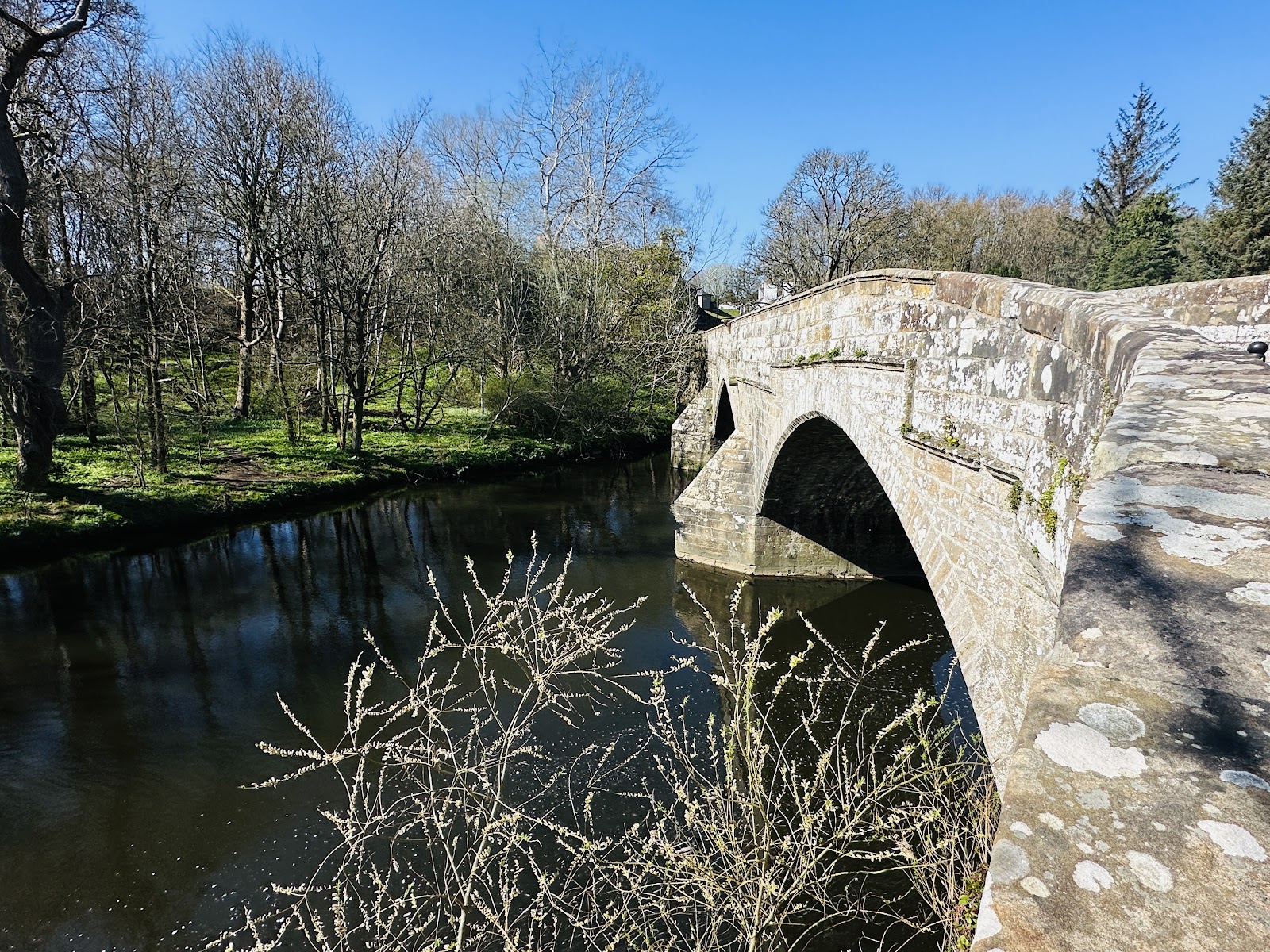 The old stone arches of Cramond Brig over the River Almond.