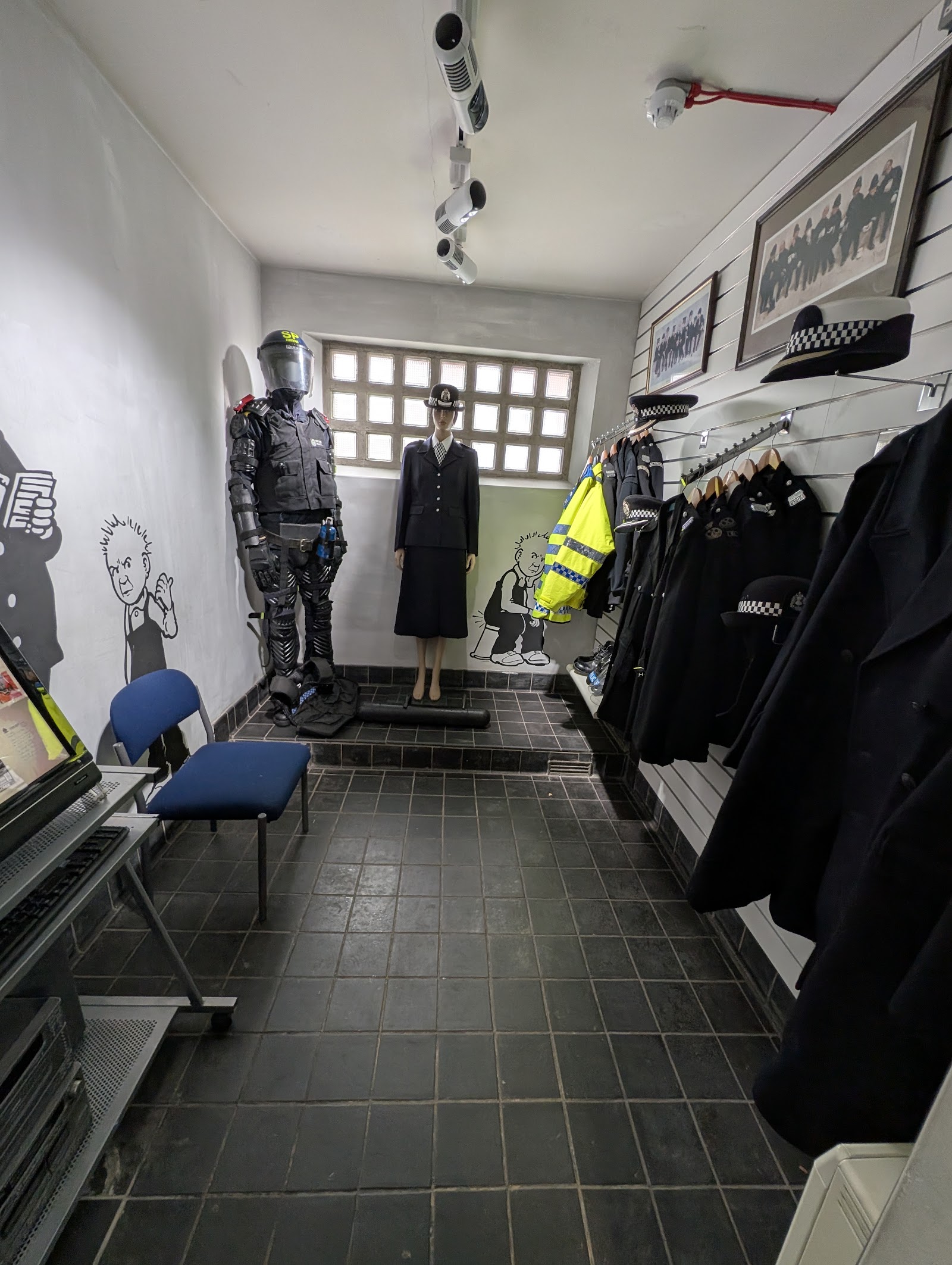 Uniforms and helmets along a corridor in the Tayside Police Museum.