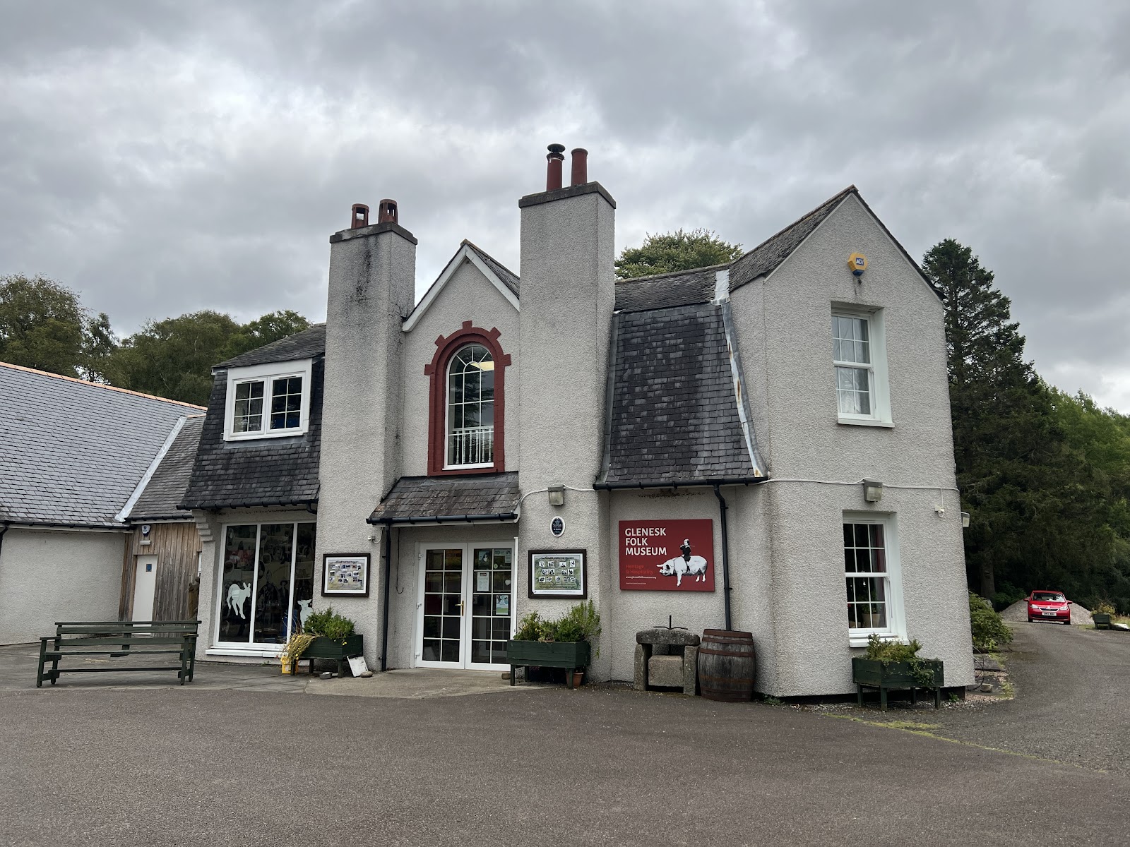 The white front of the Retreat at Tarfside, with tall chimneys and a red-framed window.