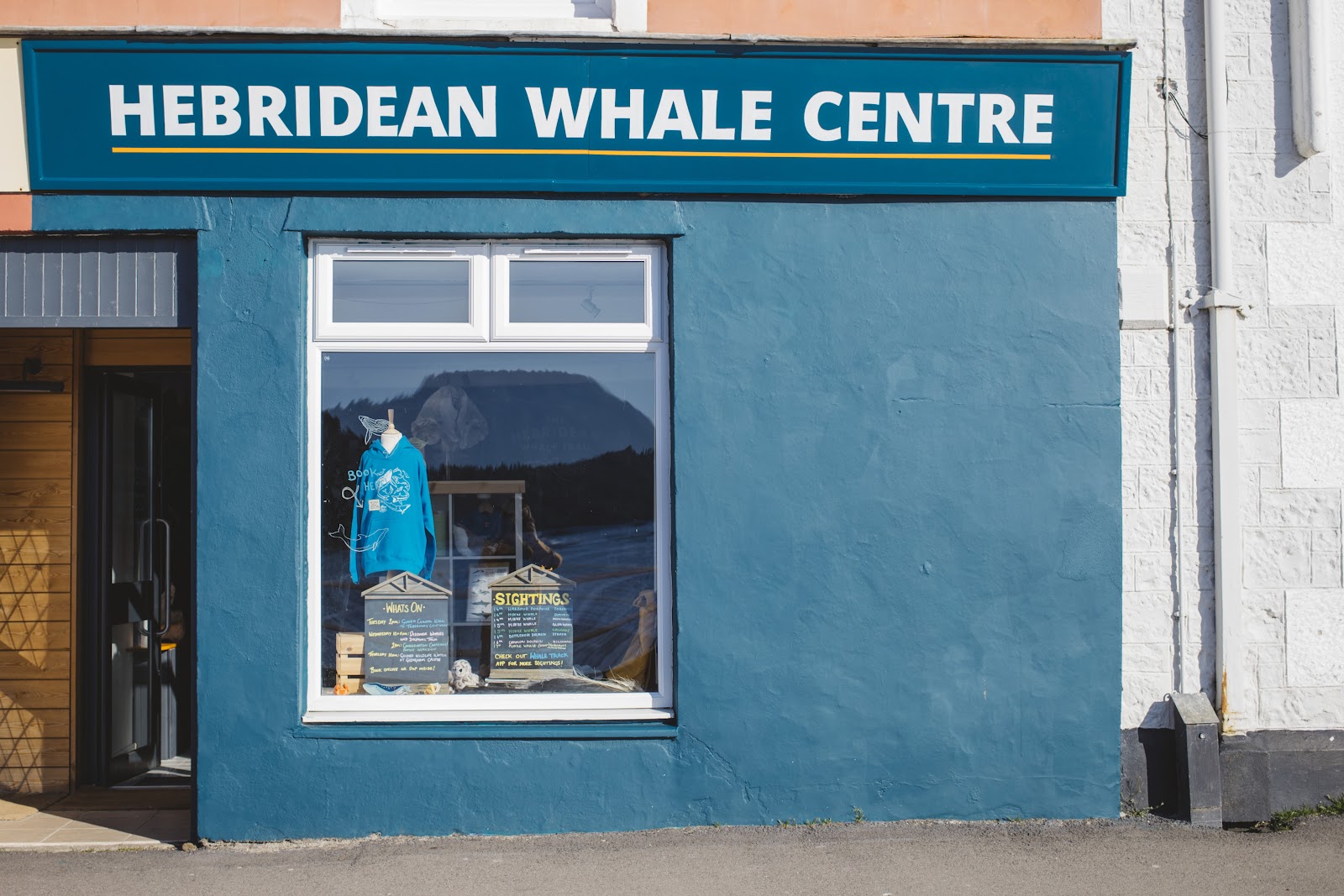 The blue front of the Hebridean Whale Centre on Tobermory's Main Street.