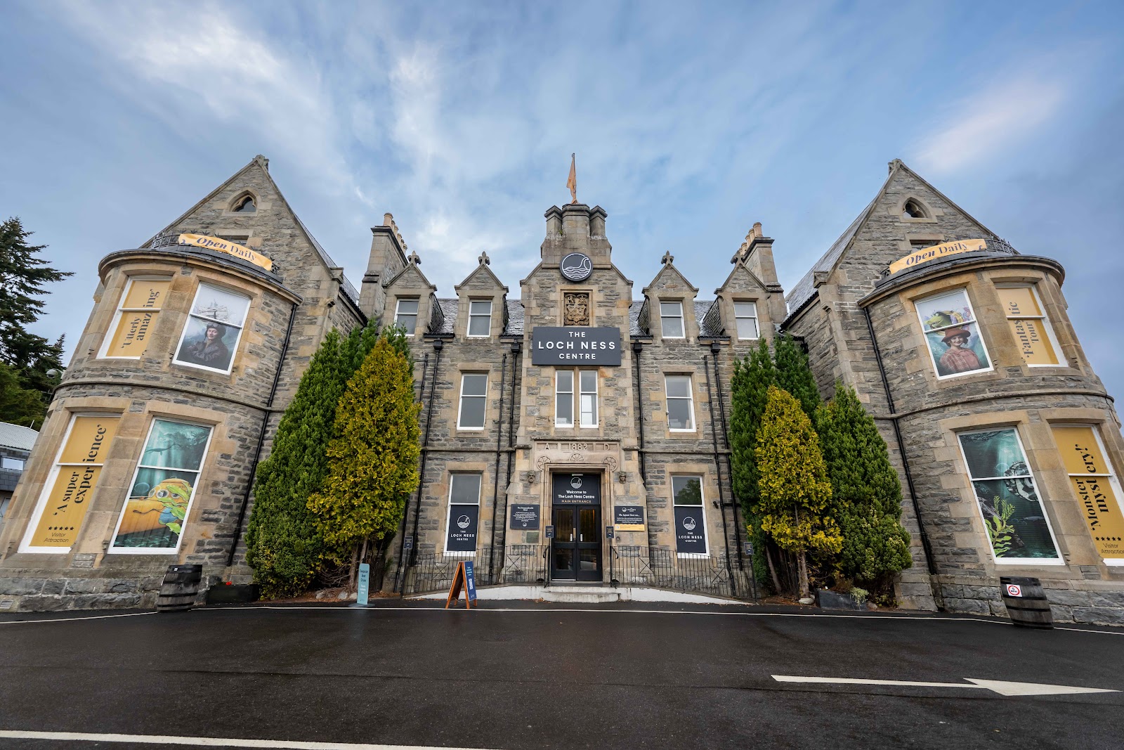 The Loch Ness Centre building, dated 1882, with twin gabled towers and window displays