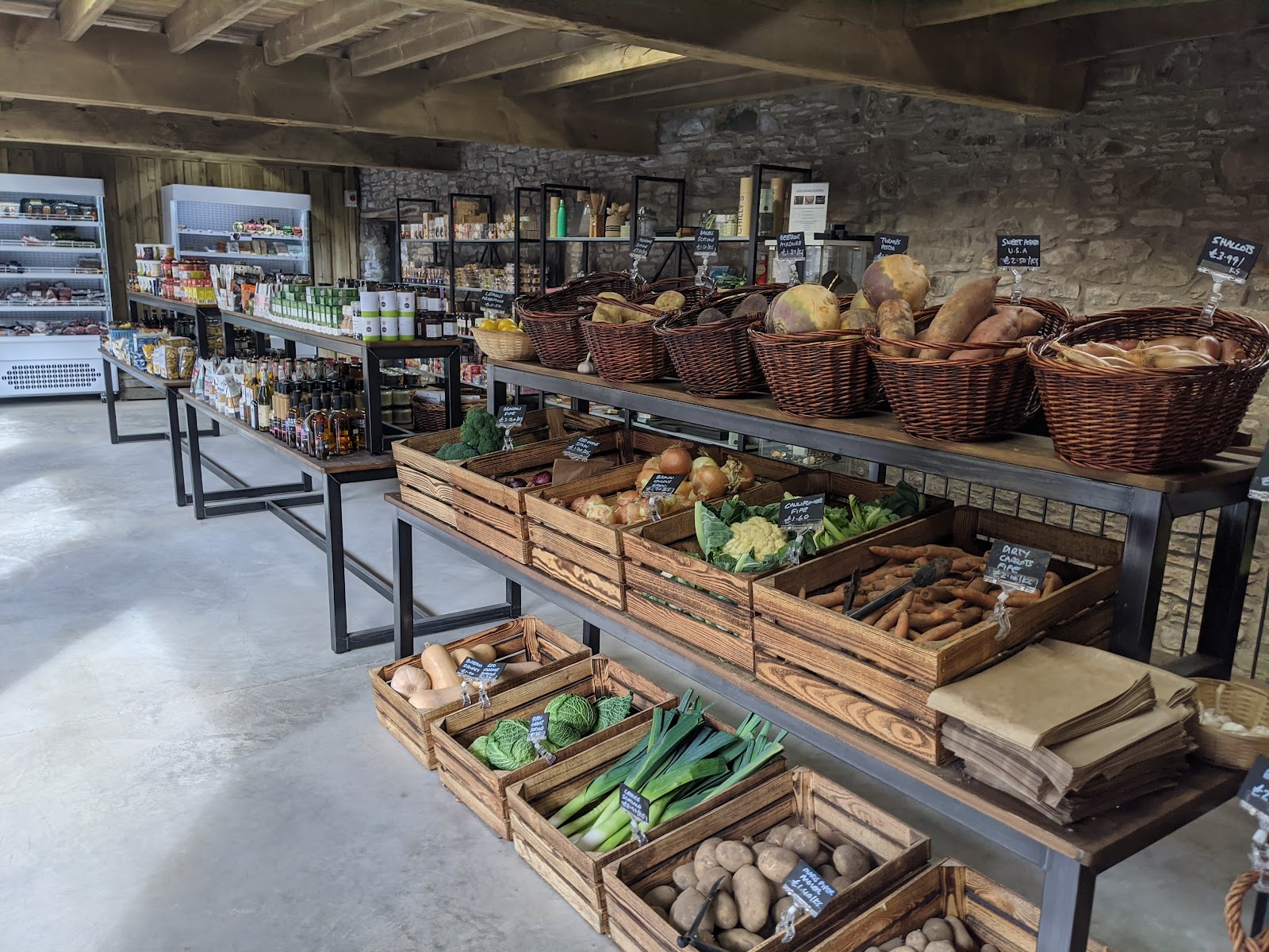 Wooden crates and baskets of vegetables in Grewar's farm shop.