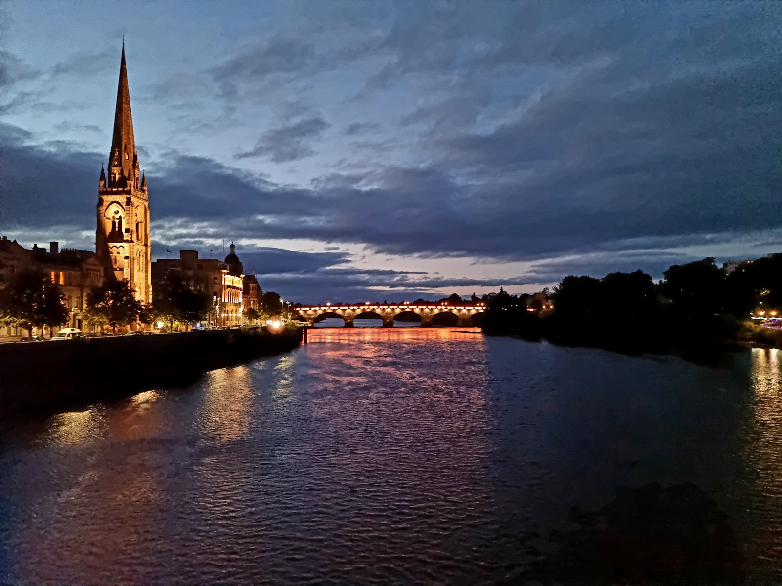 St Matthew's spire and the lights of Perth reflected in the Tay at dusk.