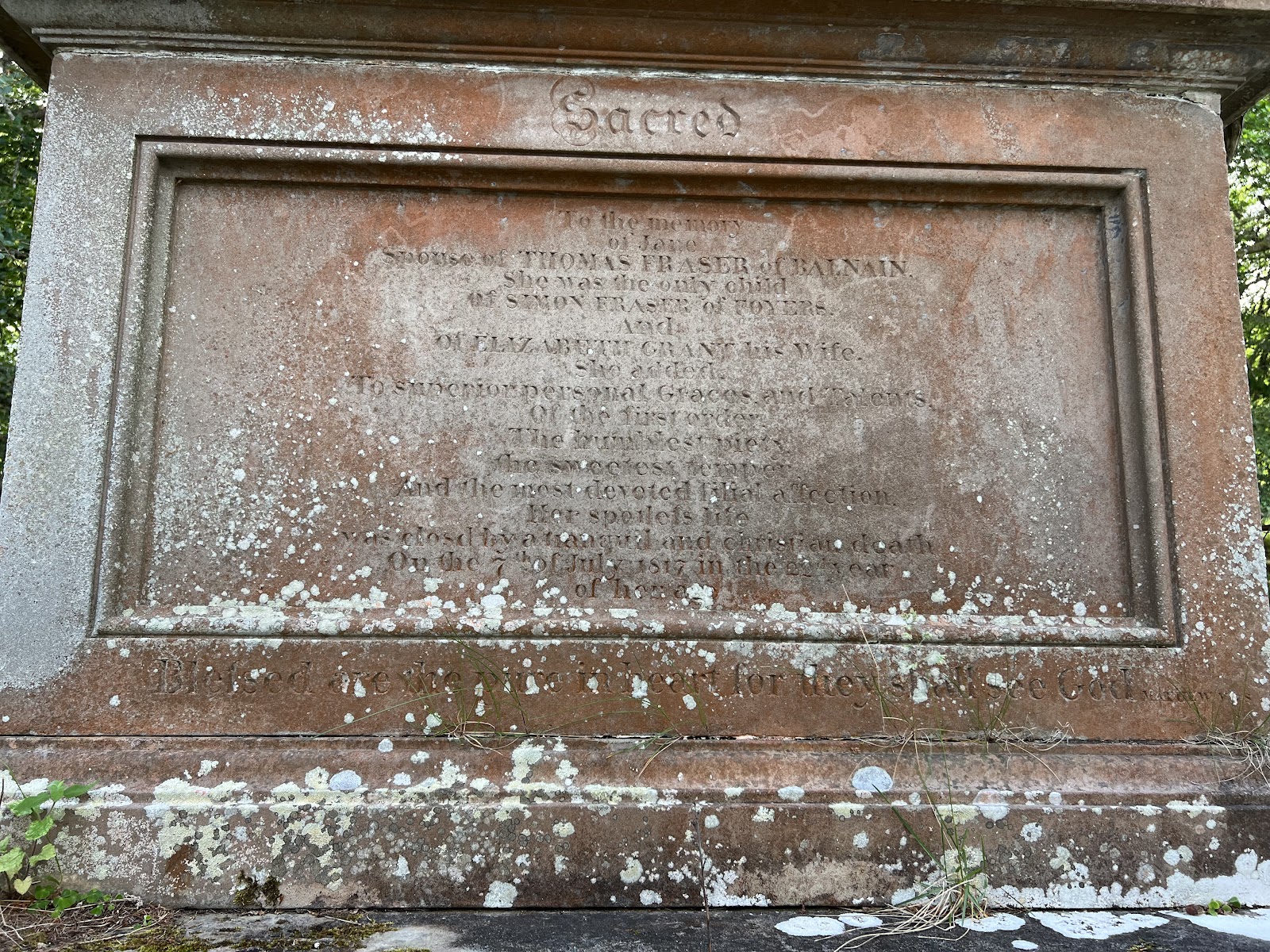 Lichen-covered gravestone inscribed "Sacred to the memory of Jane, spouse of Thomas Fraser of Balnain