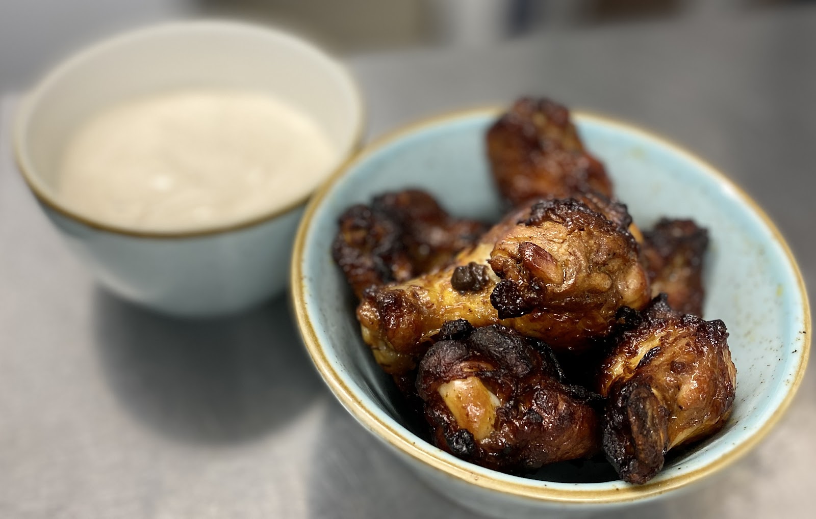 Chicken wings in a bowl with a dip at Ambience.