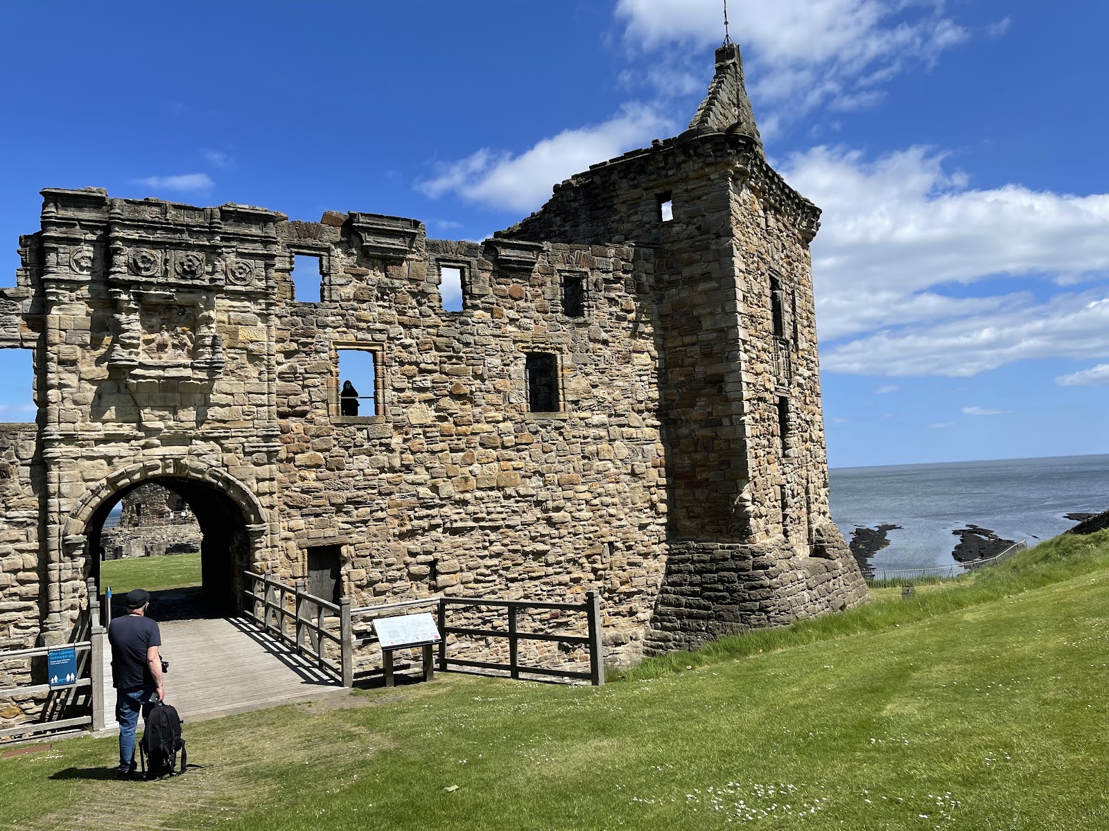 St Andrews Castle, the ruined gatehouse range and tower on the green above the sea.