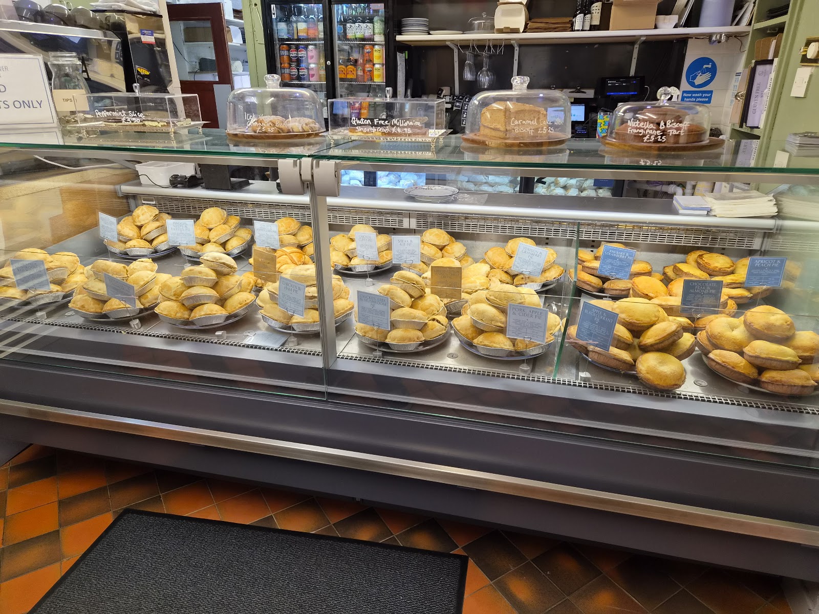 Lochinver Larder's long glass counter filled with golden pies.