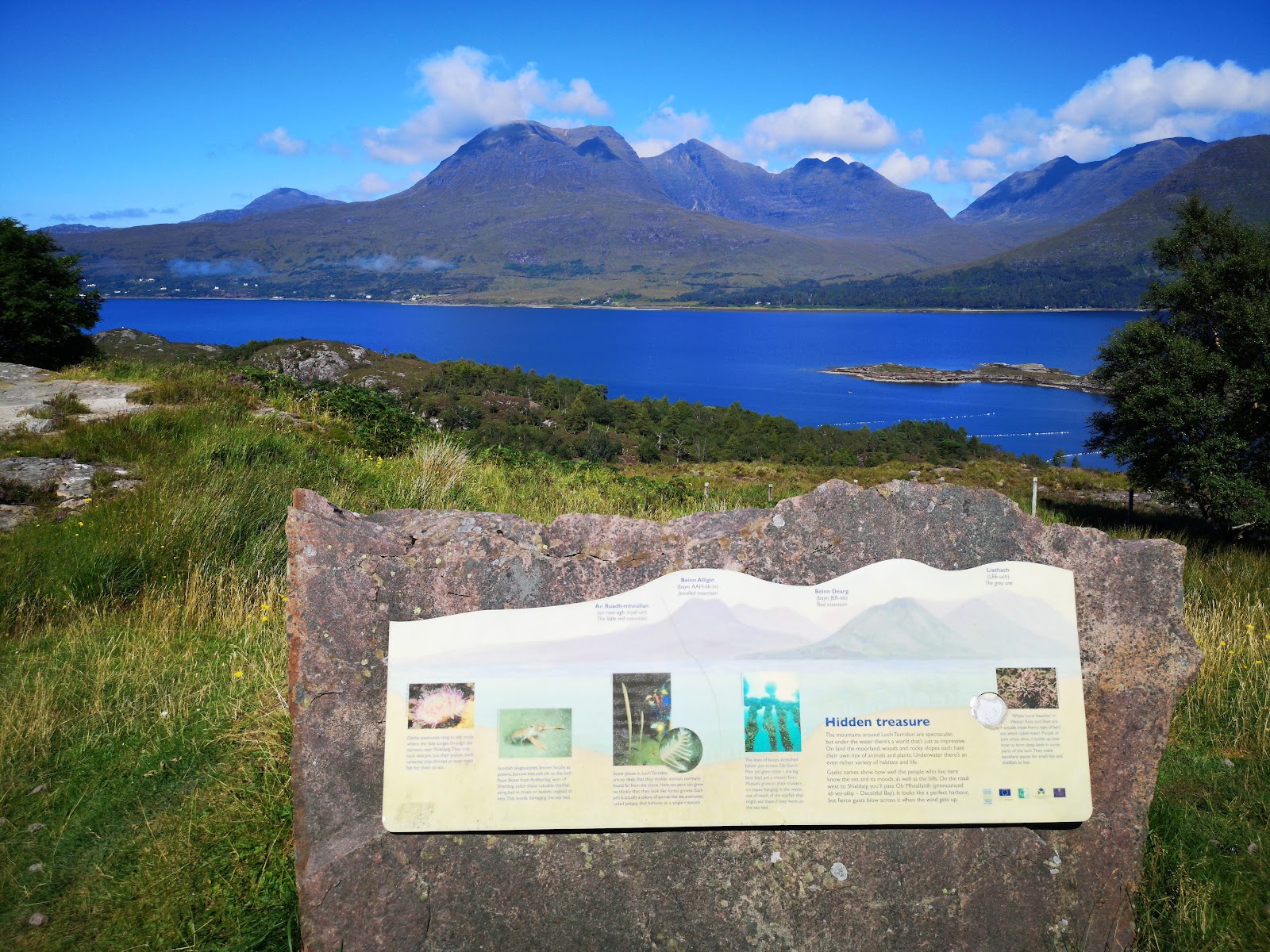 A "Hidden treasure" information plaque overlooking Loch Torridon and the surrounding mountains