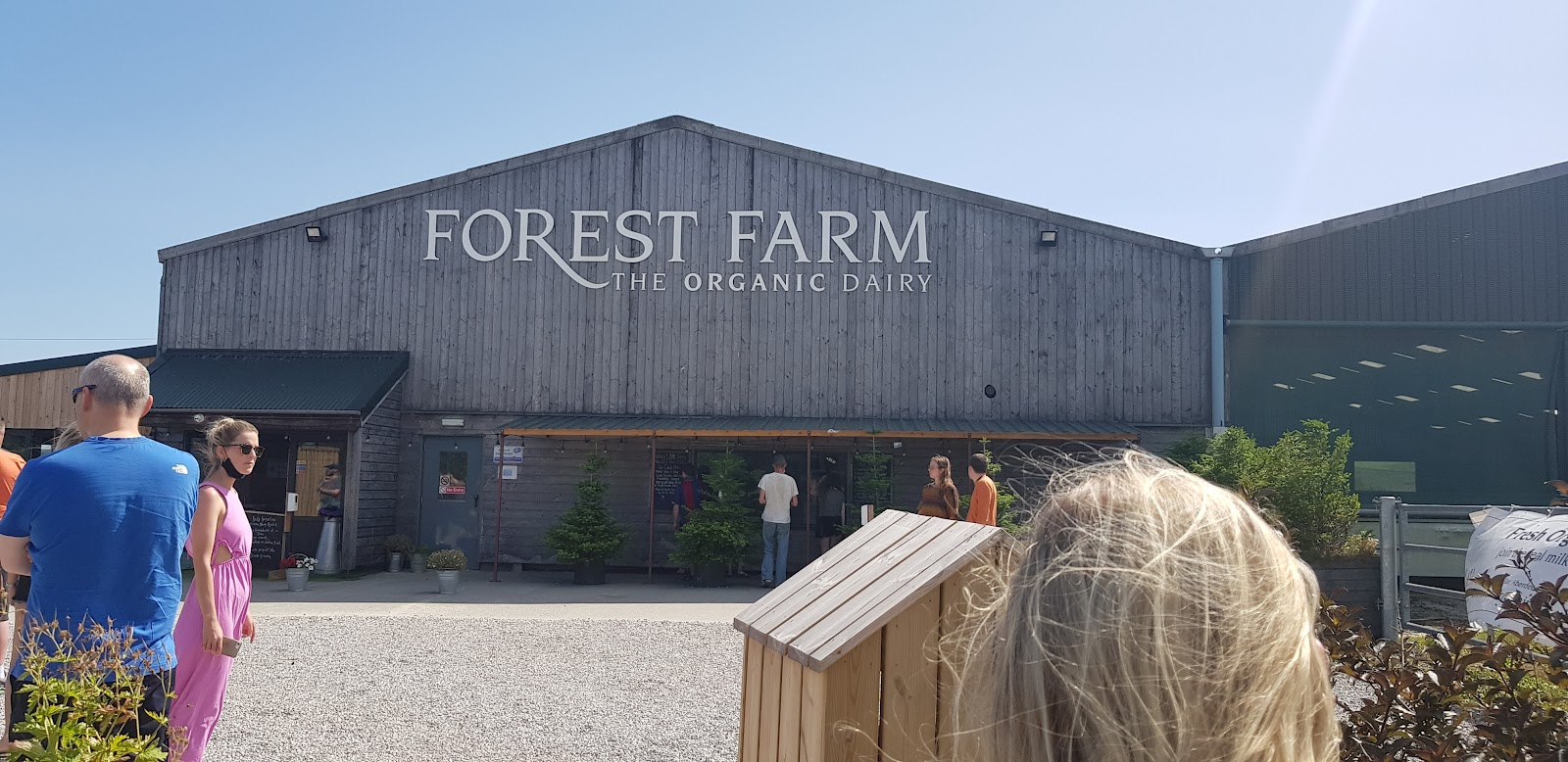 People outside the Forest Farm organic store, a photograph of another place filed under the Lighthouse.