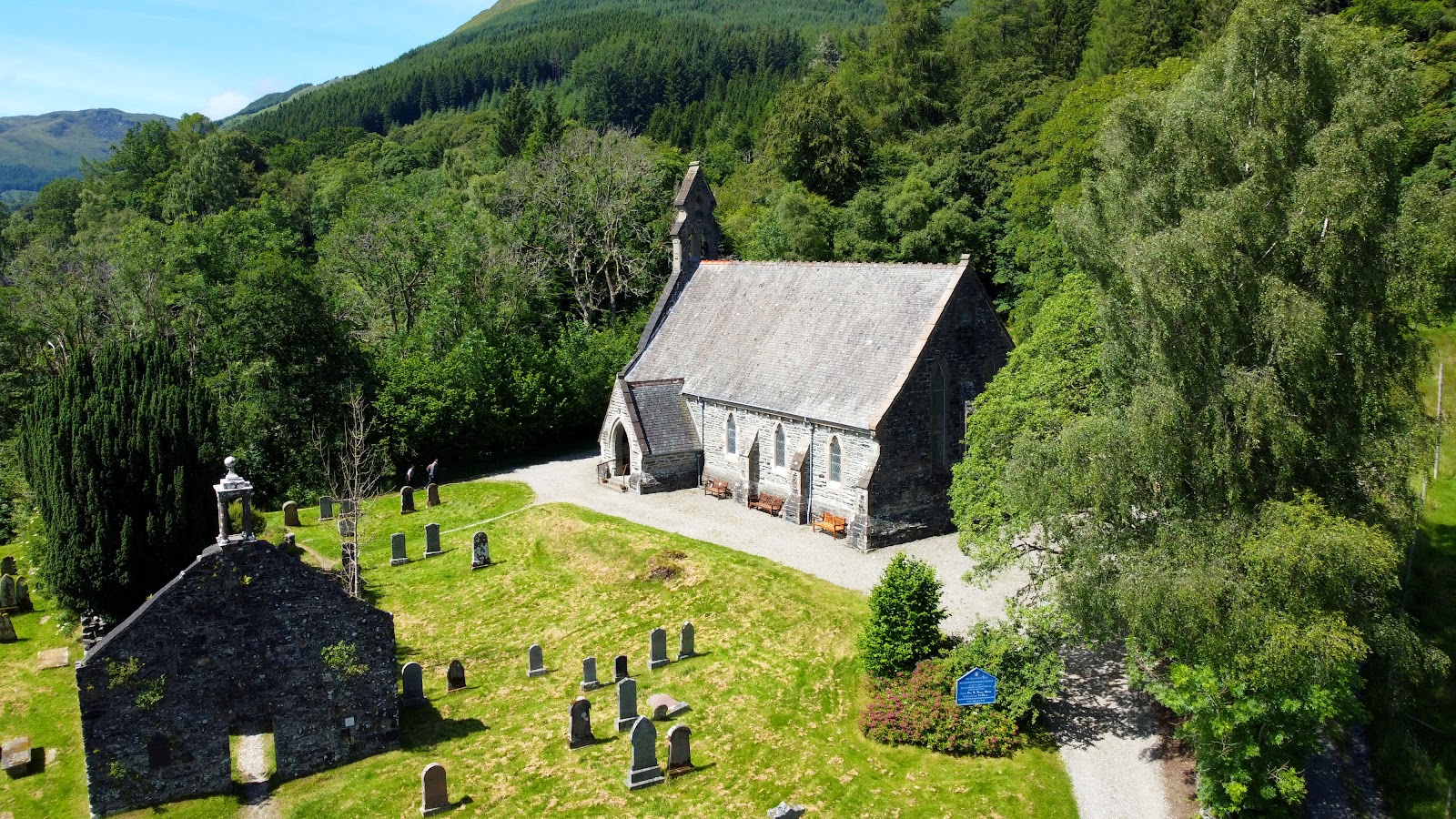 Balquhidder parish church and the ruined old kirk among trees, from the air.