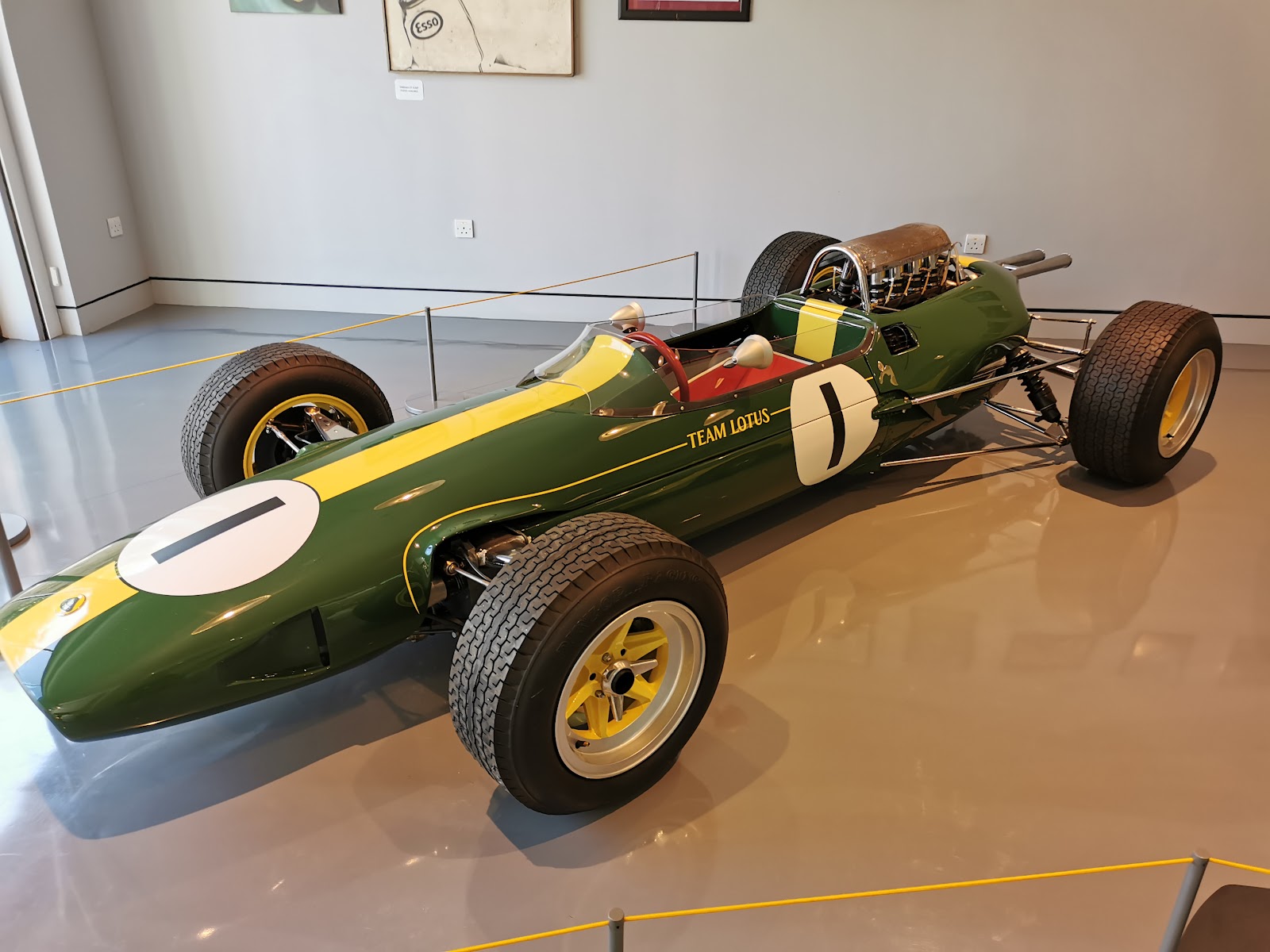 A green and yellow Lotus Formula One car with the number 1 on a gleaming floor in the Jim Clark Motorsport Museum.