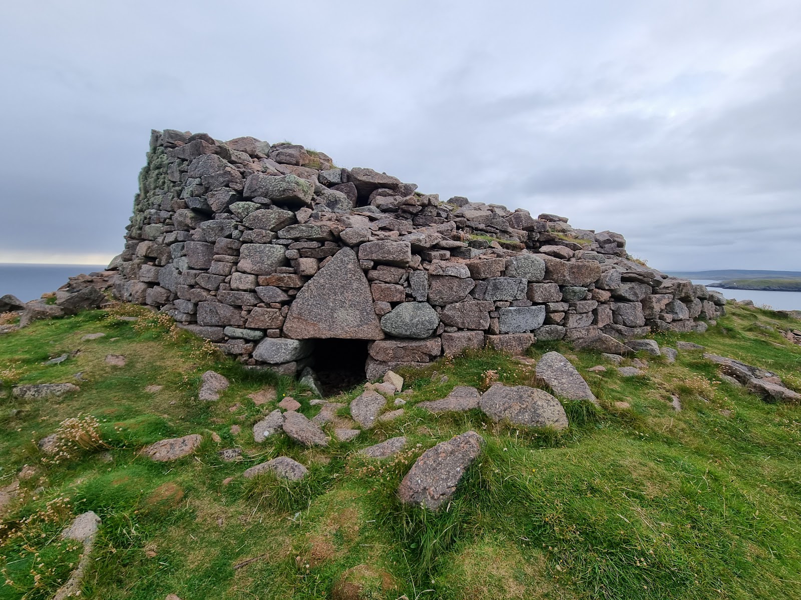 Culswick Broch's ruined wall and triangular lintel stone above the entrance.