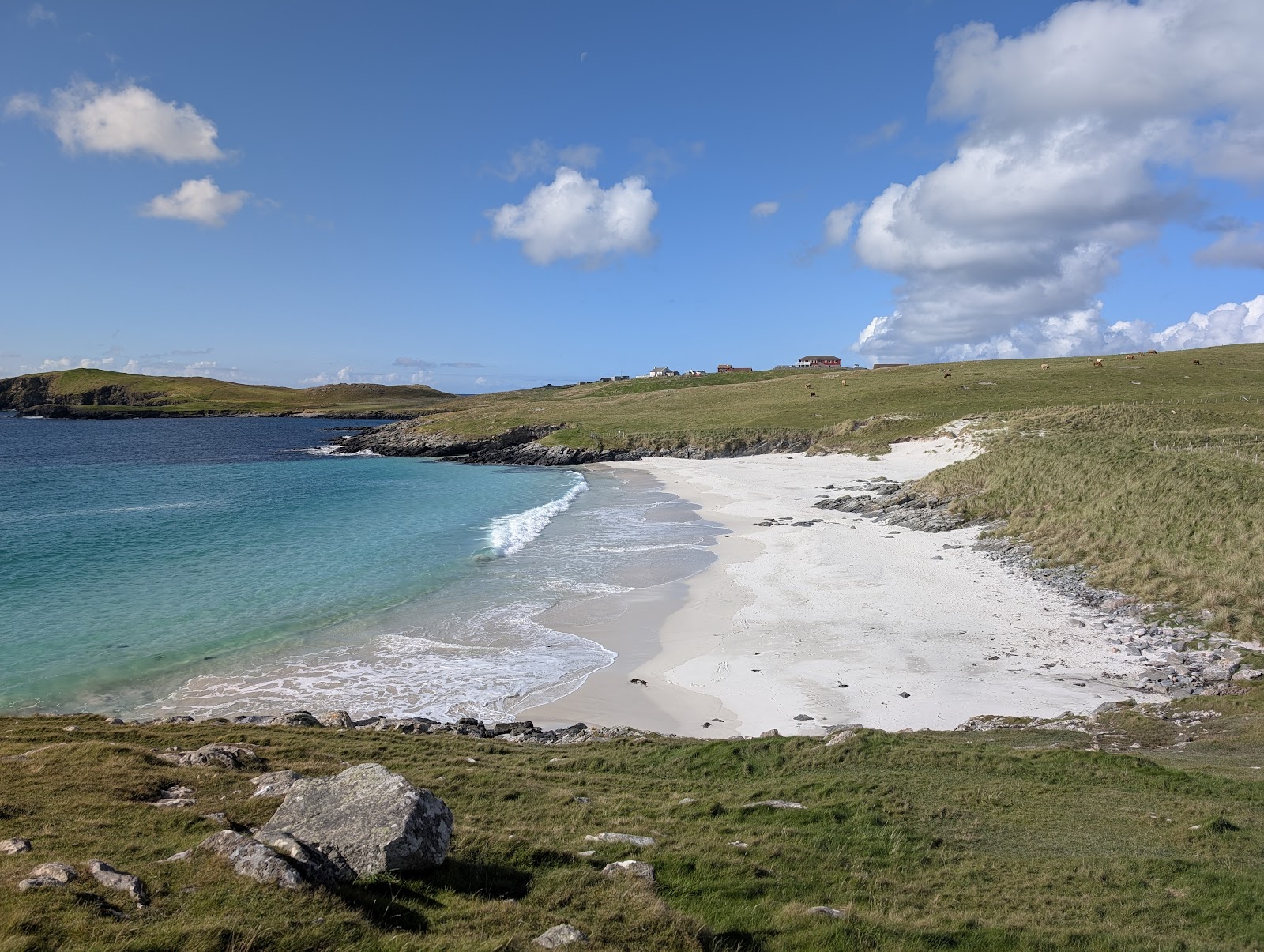 The white sand and turquoise water of Meal beach below green banks, West Burra.