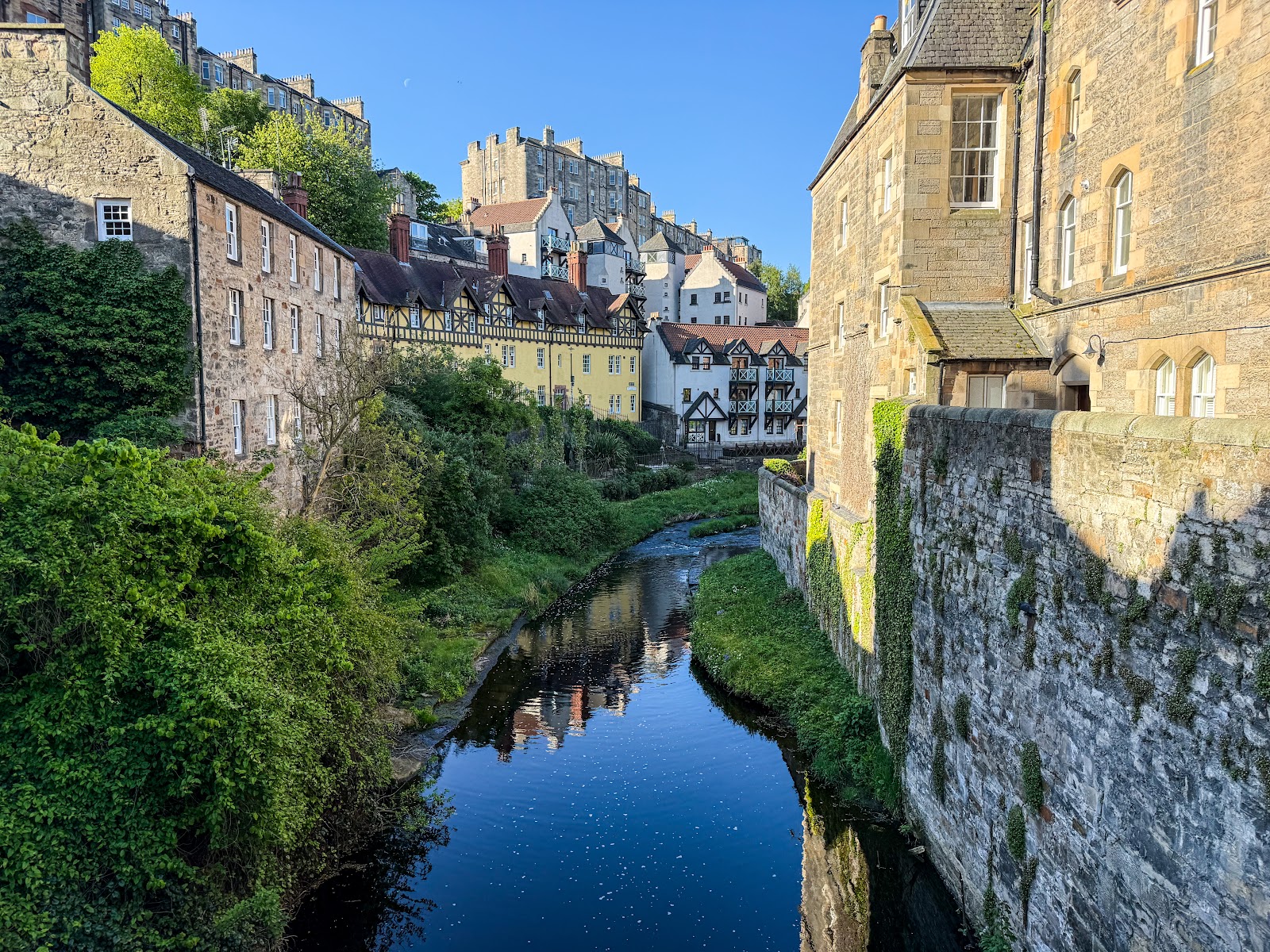 Water of Leith winds through Dean Village beneath timber-fronted tenements and stone walls