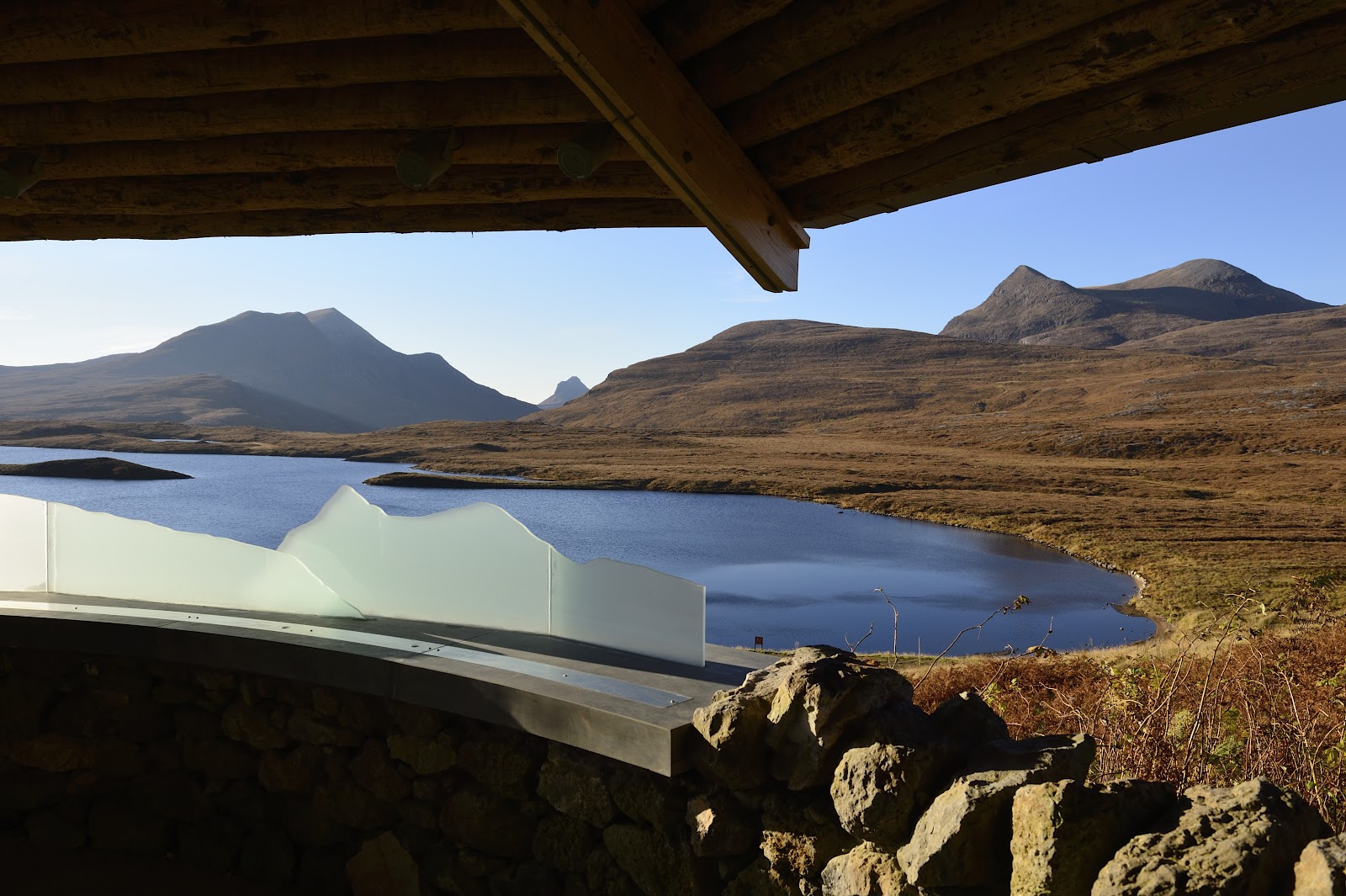 Viewpoint shelter overlooking a loch and Assynt's mountain peaks