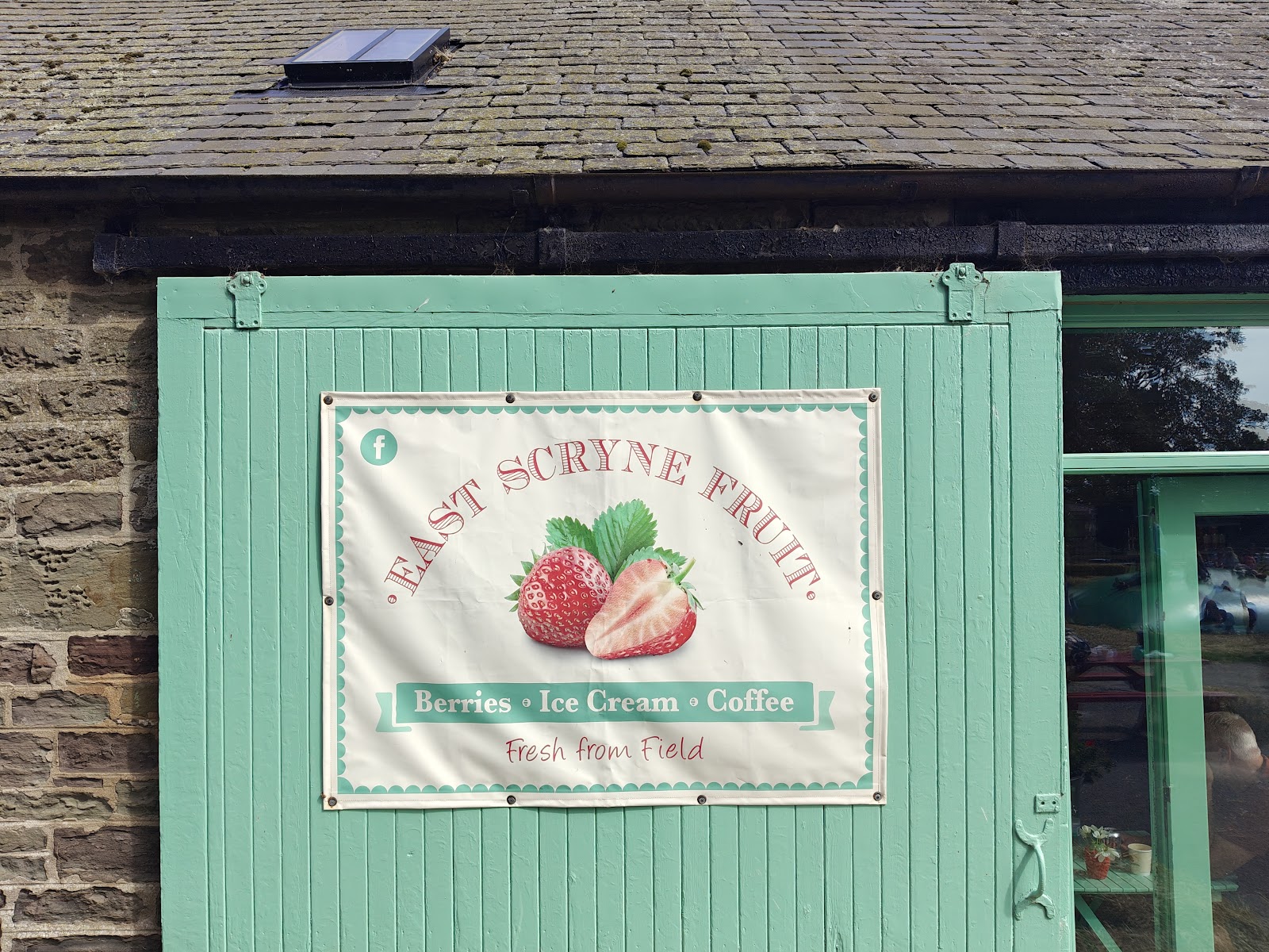 The painted sign of the East Scryne Fruit farm shop and tea room.