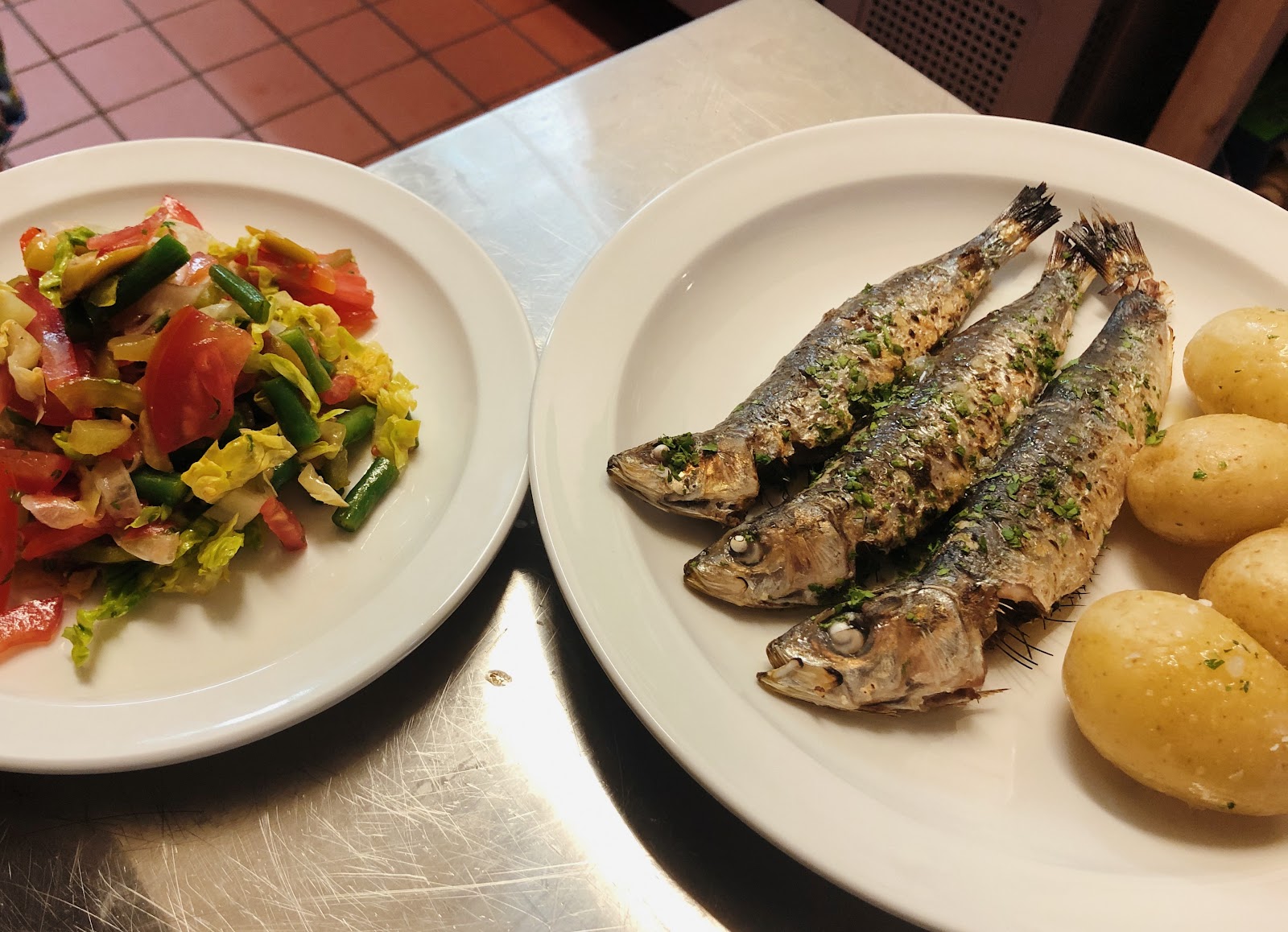 Grilled sardines with new potatoes and a salad of tomatoes and beans on the steel counter at Big Counter.