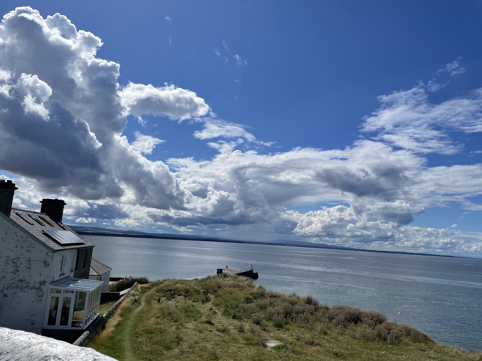 The white visitor centre on the Burghead headland above grassy ramparts and the Moray Firth.