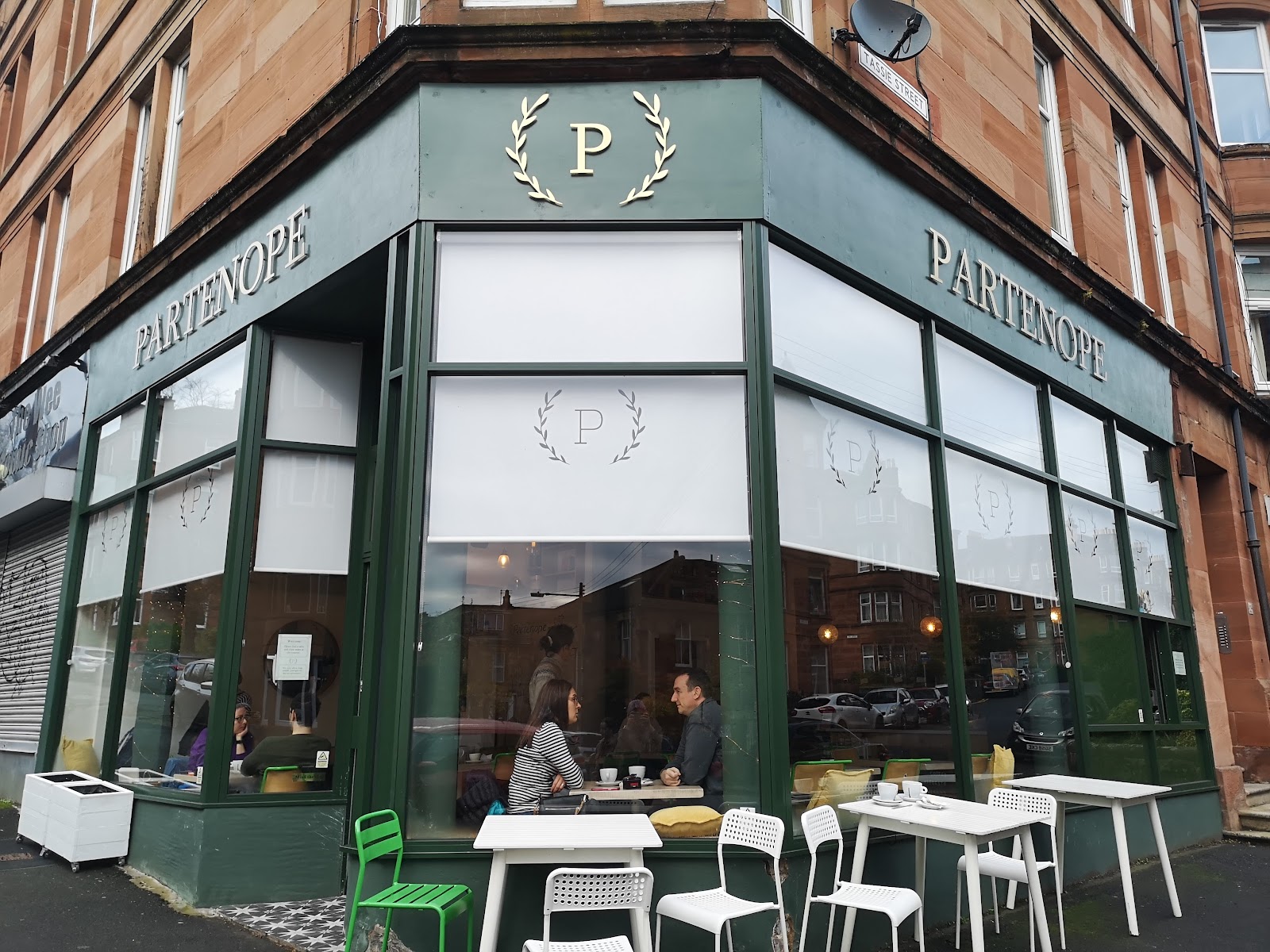 Partenope's green corner front on Hector Road in Shawlands, its name in gold above big windows and white tables outside.