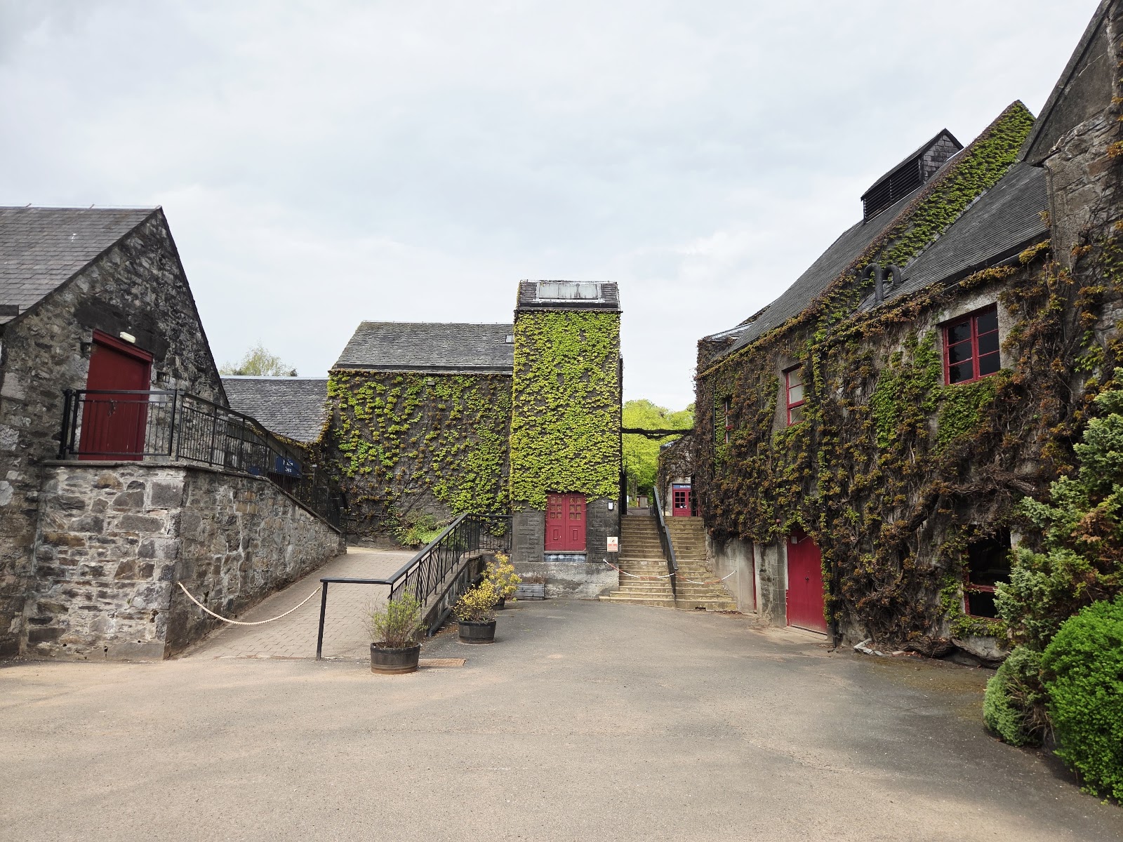 The ivy-covered courtyard of Blair Athol Distillery, its tower and stone buildings.