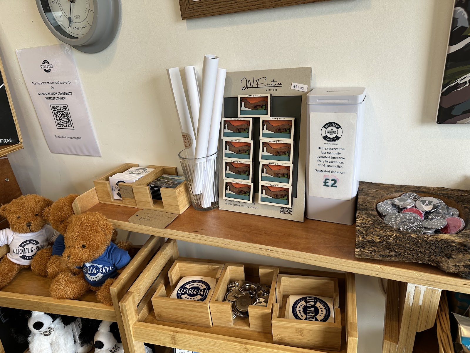 Shelves in the Shore Station shop with teddy bears in Skye Ferry jumpers, prints and small gifts.