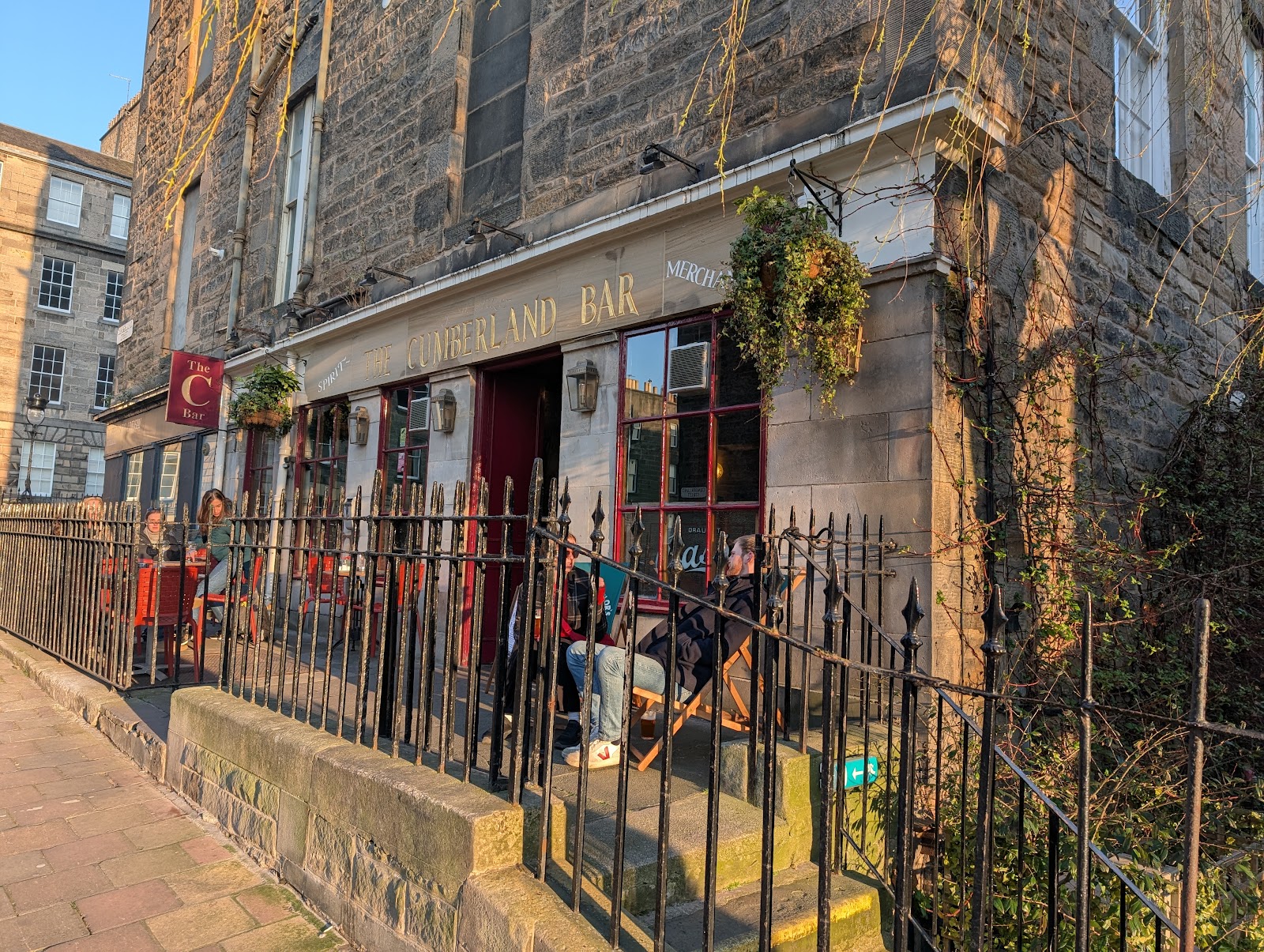 The Cumberland Bar on the corner of Cumberland Street, its garden behind iron railings.
