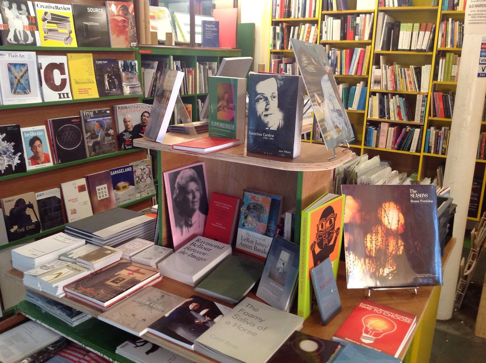 Shelves packed with books and tables of books faced outwards.