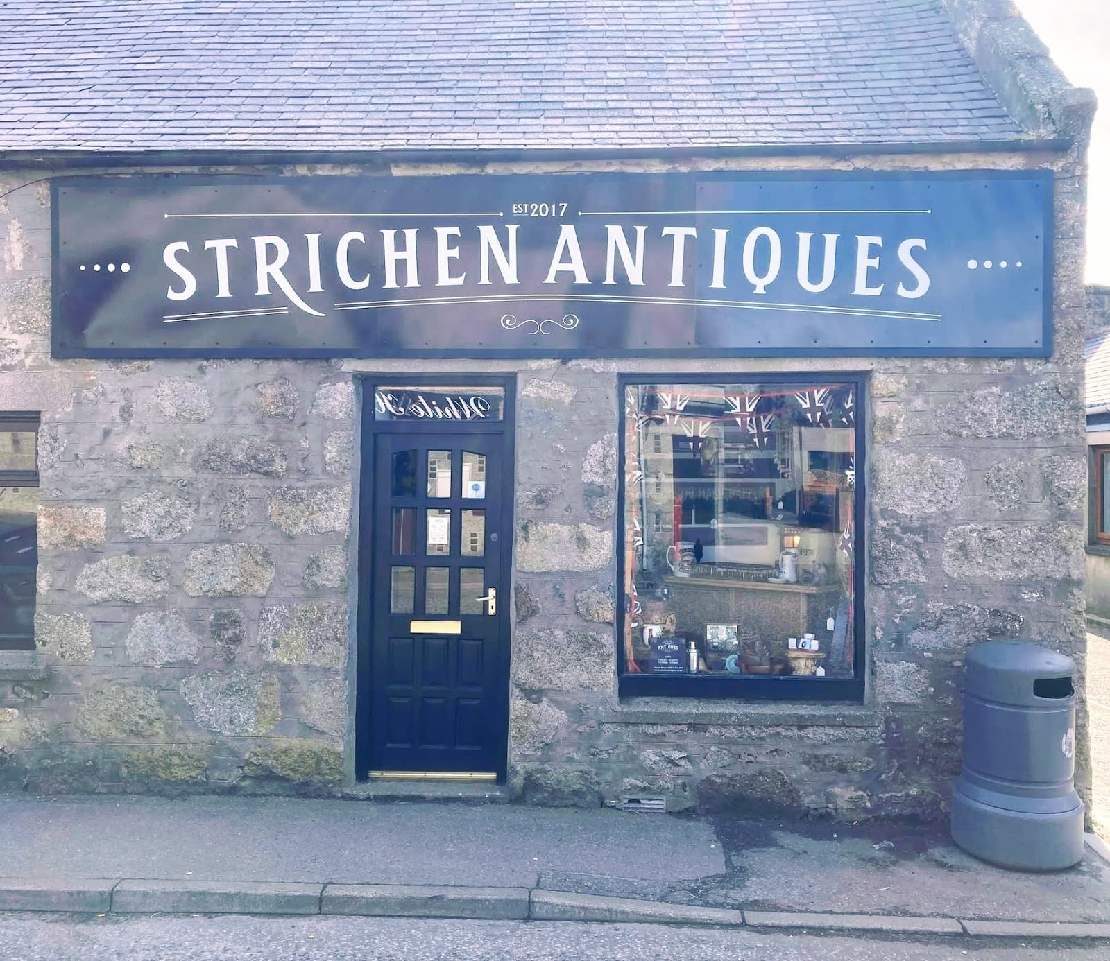 The blue front of Strichen Antiques under its sign.