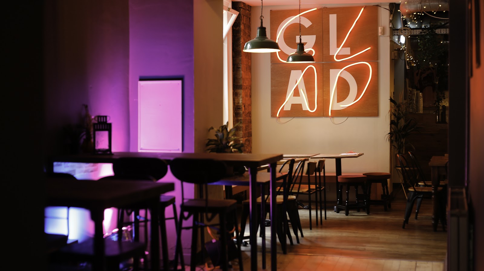 The bar under a neon GLAD sign and purple light.
