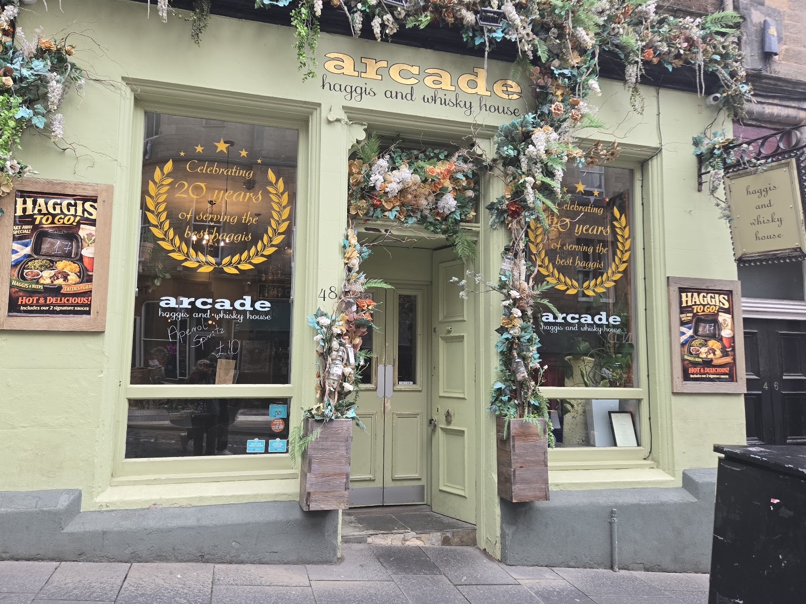 The pale green front of the Arcade on Cockburn Street, hung with flowers.