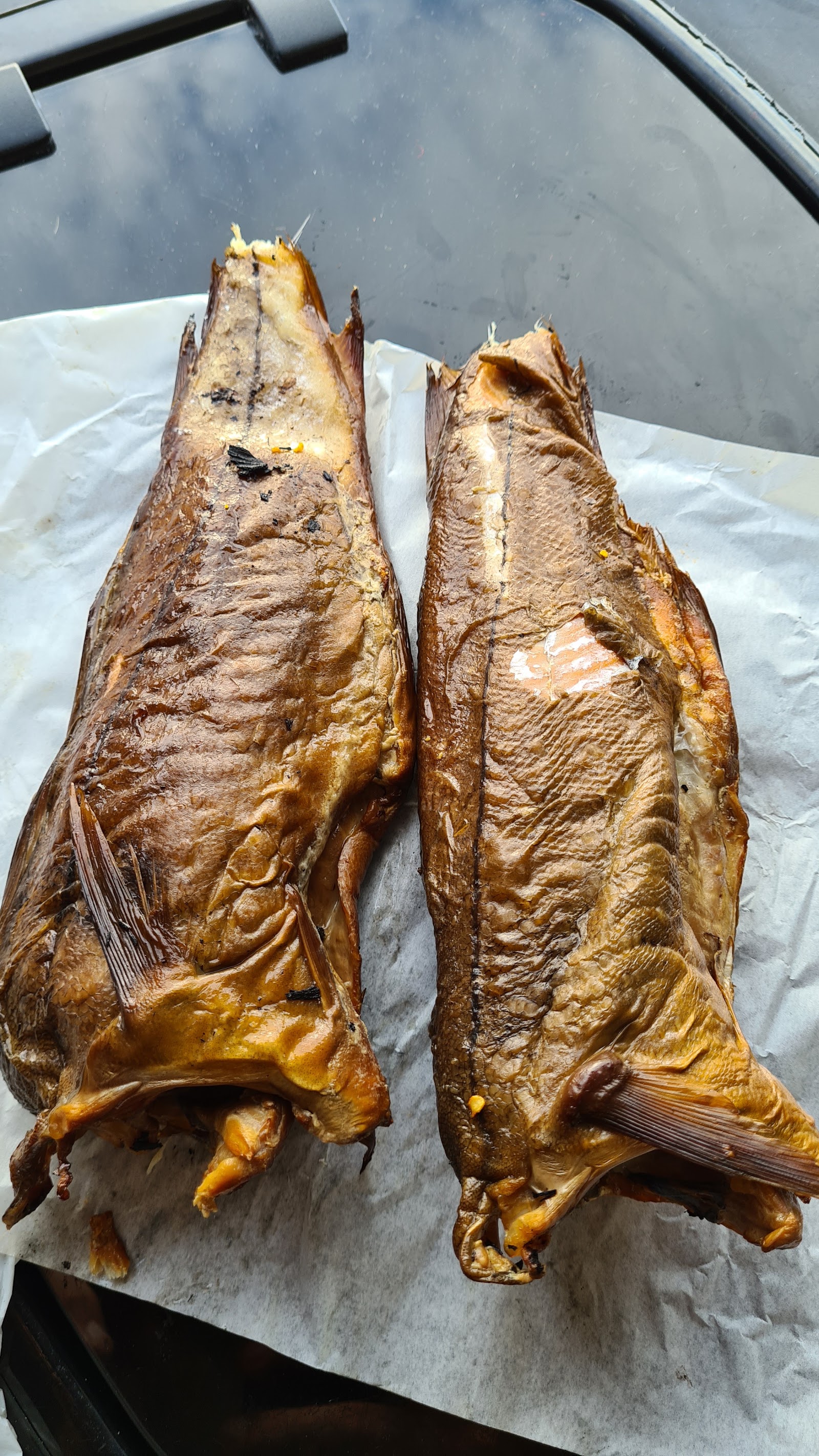 A pair of Arbroath smokies, their skins shining gold.