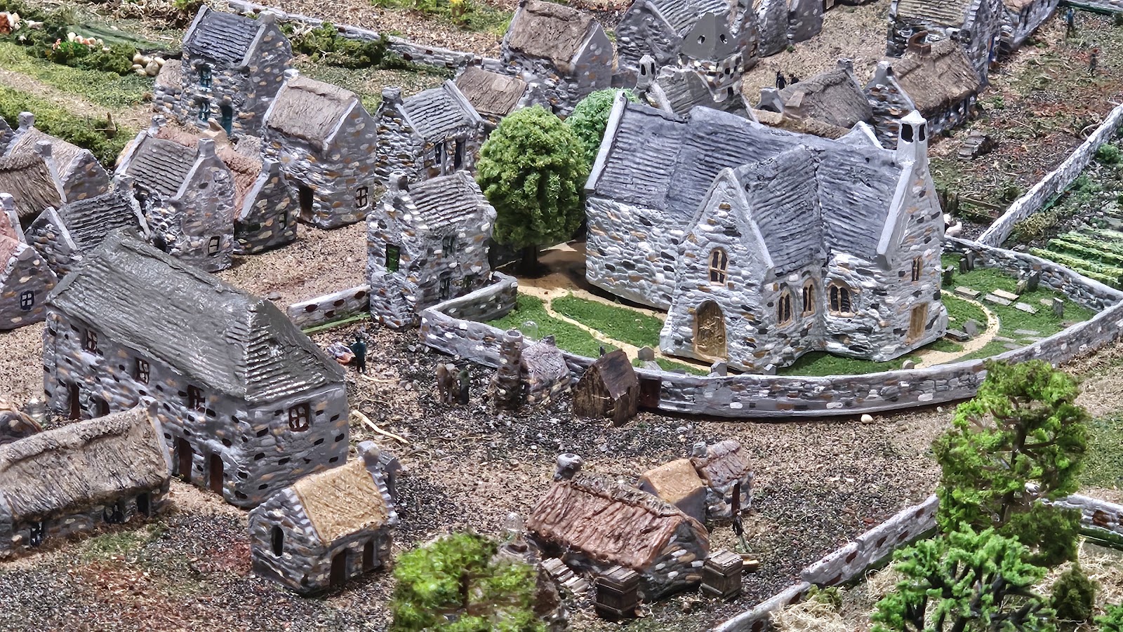 The scale model of old Cullen in the Heritage Centre, grey stone cottages and the Auld Kirk among little gardens and trees.